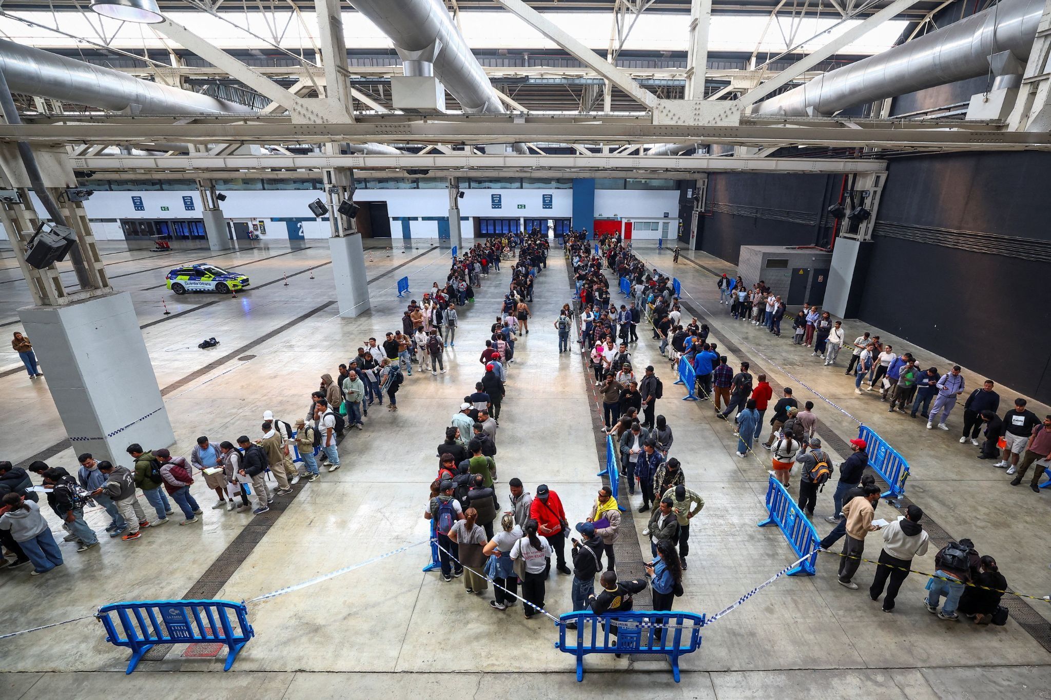 Migrants queue at a Spanish airport