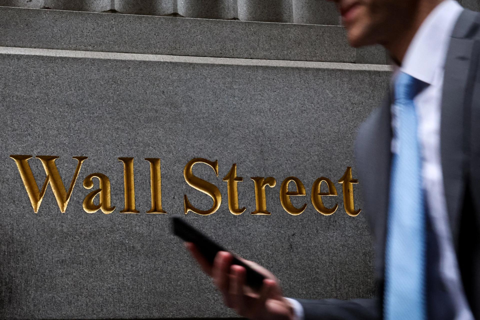 A man walks on Wall Street