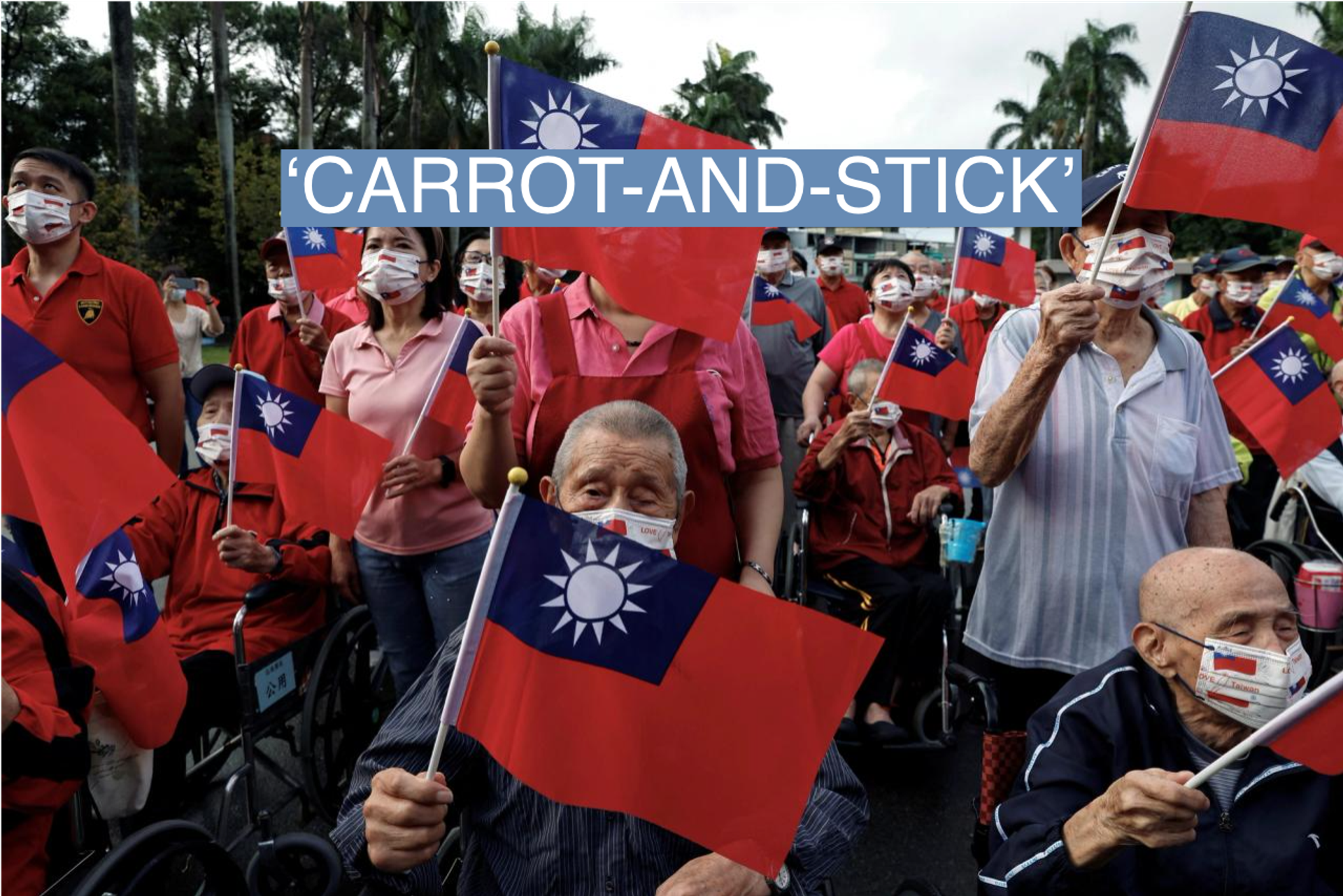 Residents and caretakers at Taoyuan Veterans Home wave Taiwanese flags while celebrating National Day in Taoyuan, Taiwan October 10, 2023.