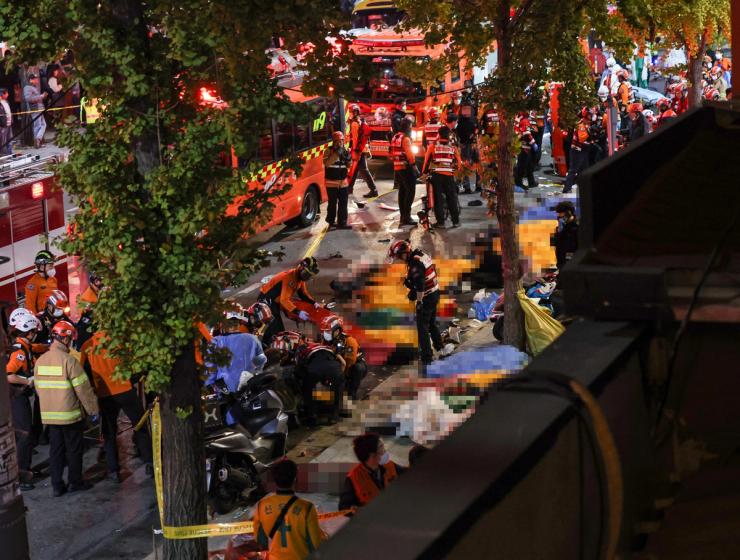 Rescue team and firefighters work on the scene where dozens of people were injured in a stampede during Halloween festival in Seoul, South Korea, October 30, 2022
