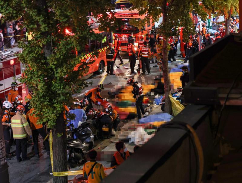 Rescue team and firefighters work on the scene where dozens of people were injured in a stampede during Halloween festival in Seoul, South Korea, October 30, 2022