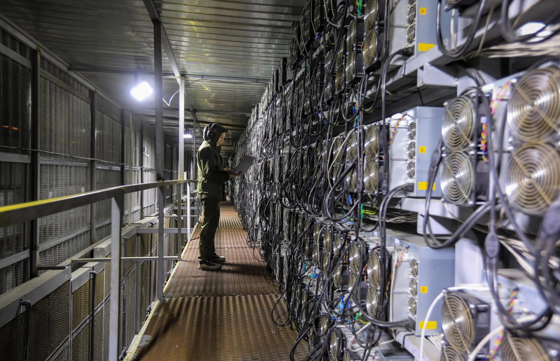 A maintenance specialist works inside the data center of the BTC KZ crypto mining company located near the coal-fired thermal power plant outside the town of Ekibastuz, Kazakhstan