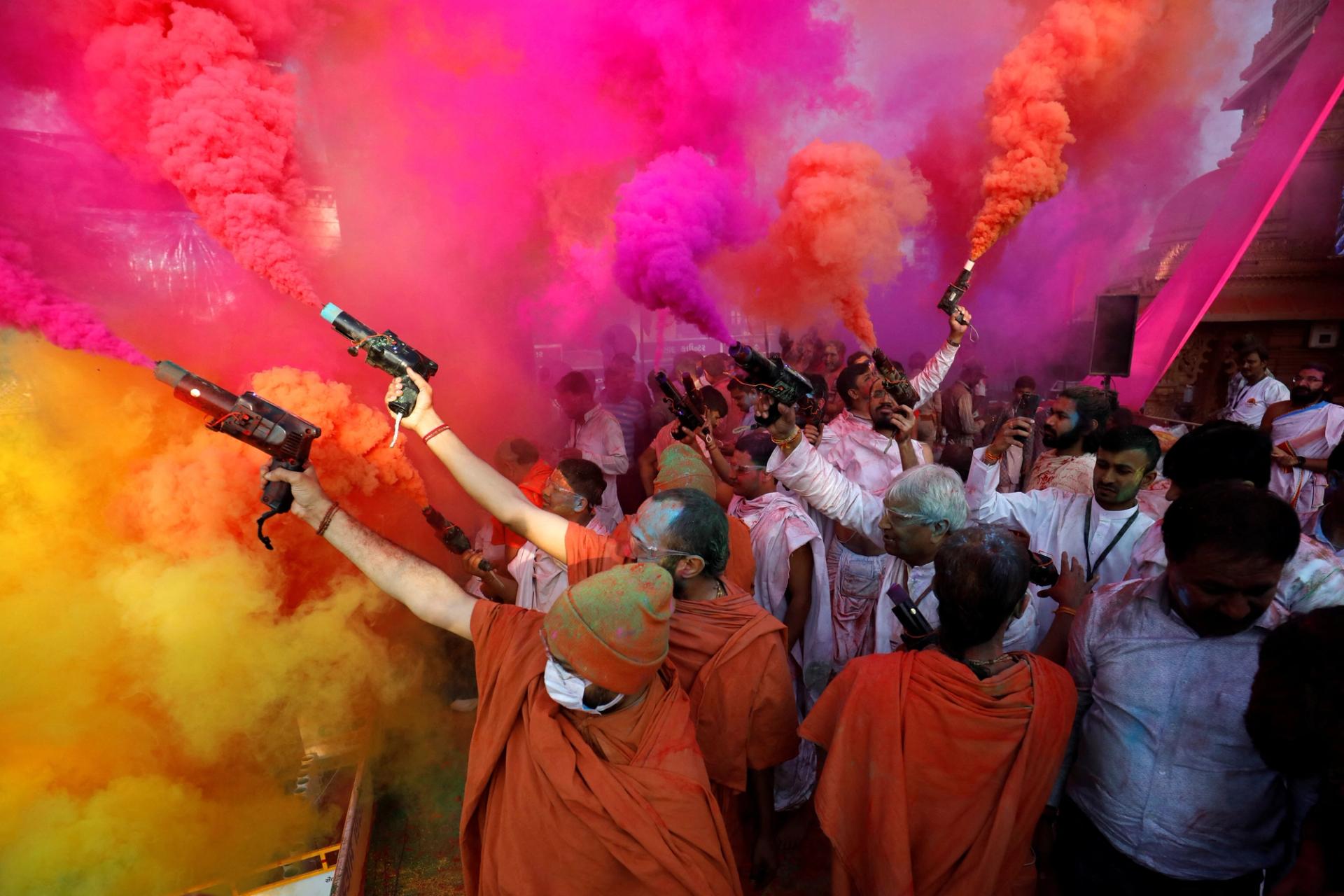 Hindu priests use colour smoke guns to celebrate Holi, the festival of colours, at a temple premises in Salangpur, in the western state of Gujarat, India, March 7, 2023. REUTERS/Amit Dave