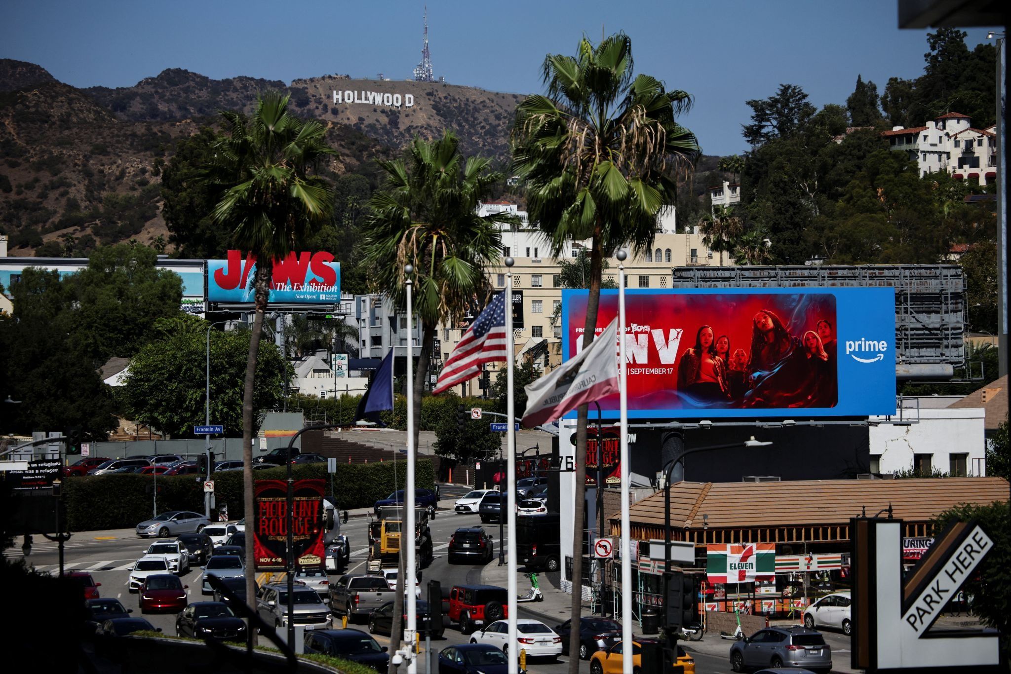 Traffic circulates below the Hollywood Sign.