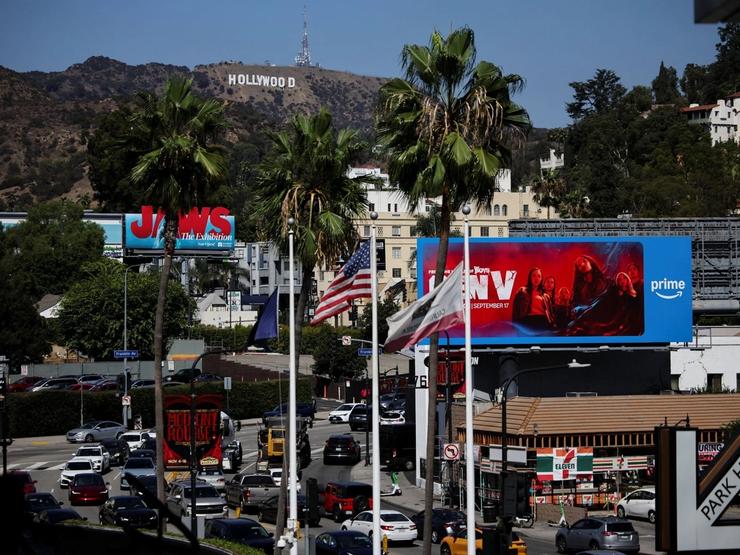 Traffic circulates below the Hollywood Sign.