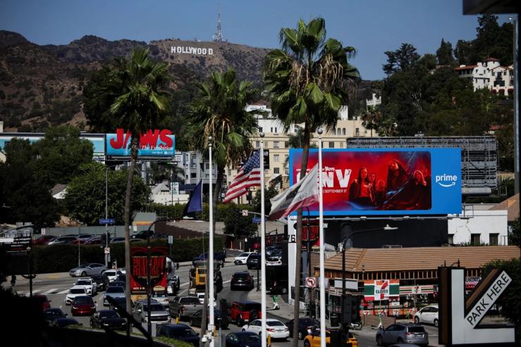 Traffic circulates below the Hollywood Sign.