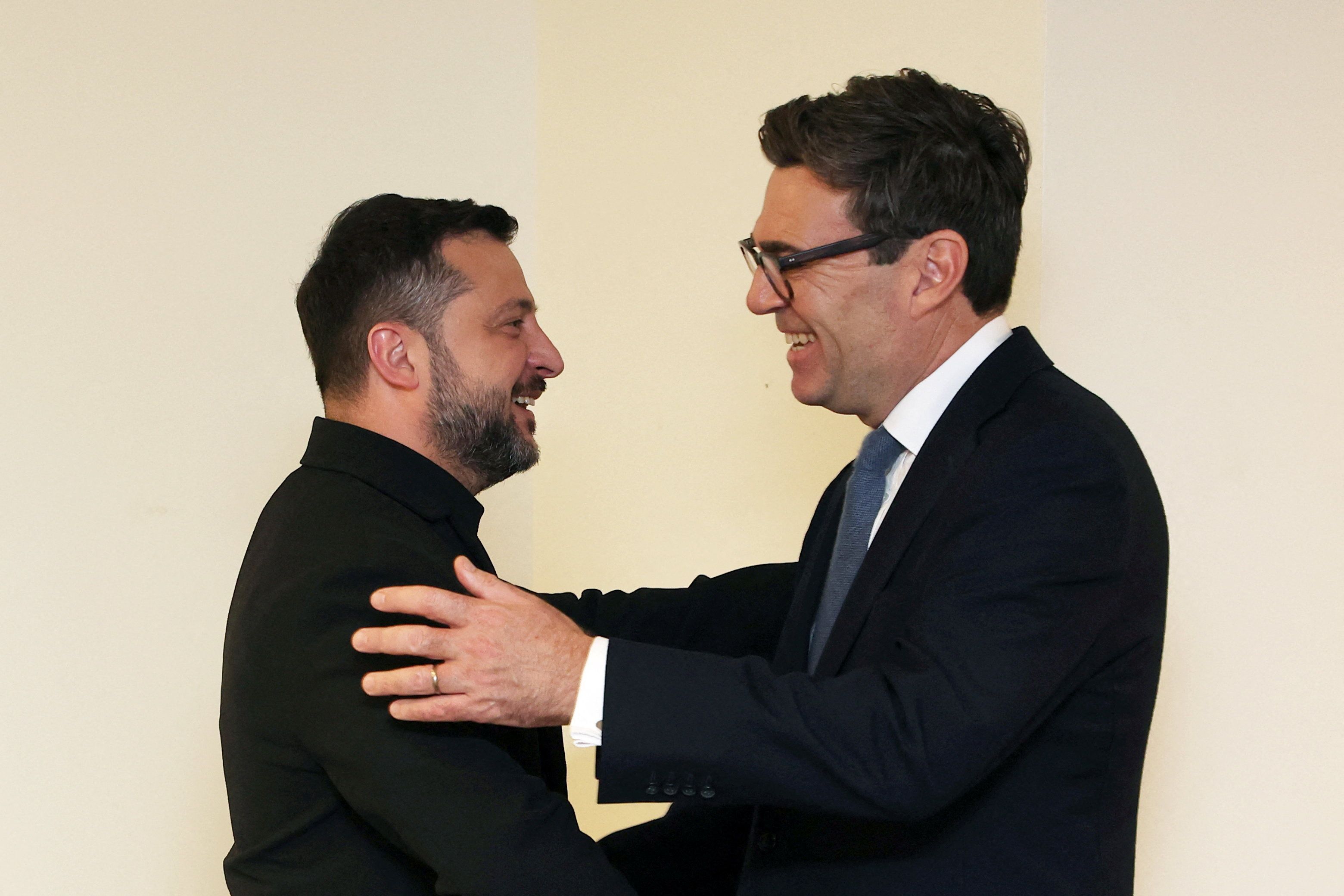Britain’s Prime Minister Andy Burnham embraces Ukrainian President Volodymyr Zelenskyy