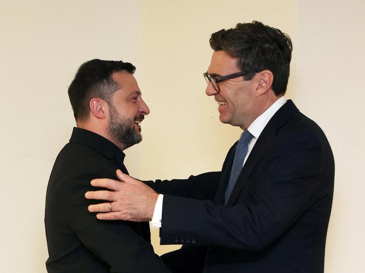 Britain’s Prime Minister Andy Burnham embraces Ukrainian President Volodymyr Zelenskyy