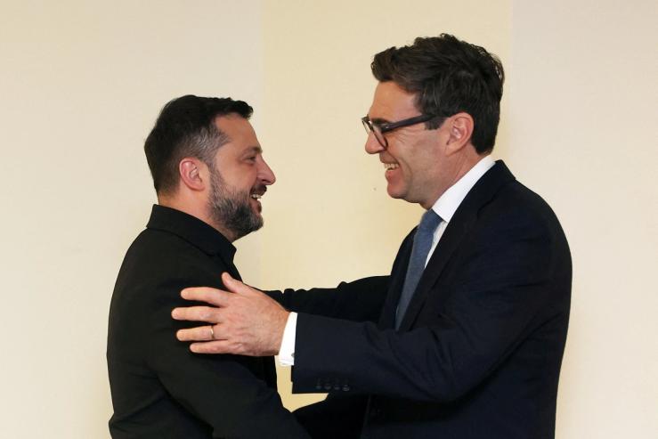 Britain’s Prime Minister Andy Burnham embraces Ukrainian President Volodymyr Zelenskyy