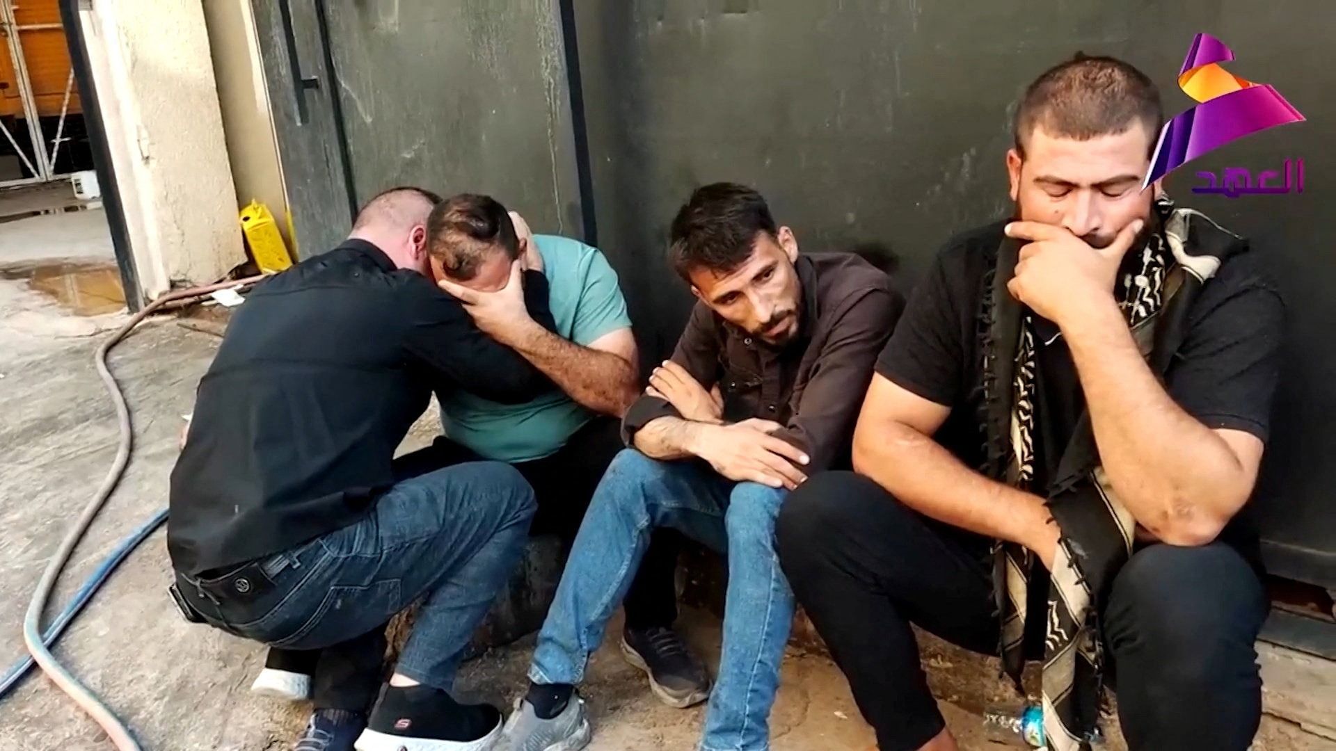 People react near Al Hamdaniya General Hospital in Mosul, Iraq, after members of Iraq’s Popular Mobilization Forces (PMF) were killed in US/Saudi strikes on the group’s bases, according to Al Ahad footage.