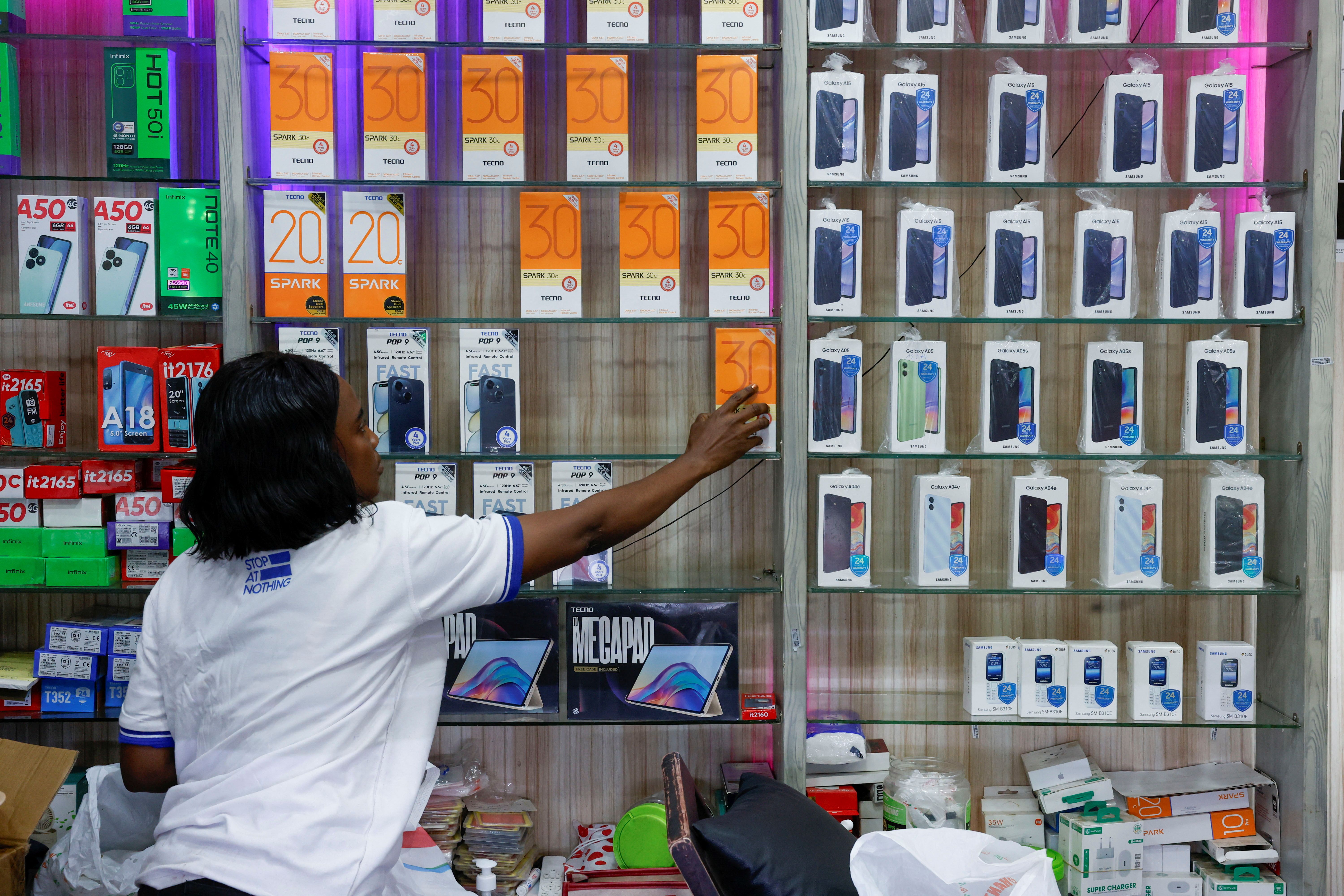 A worker of Digital Market, a store selling smartphones and accessories.
