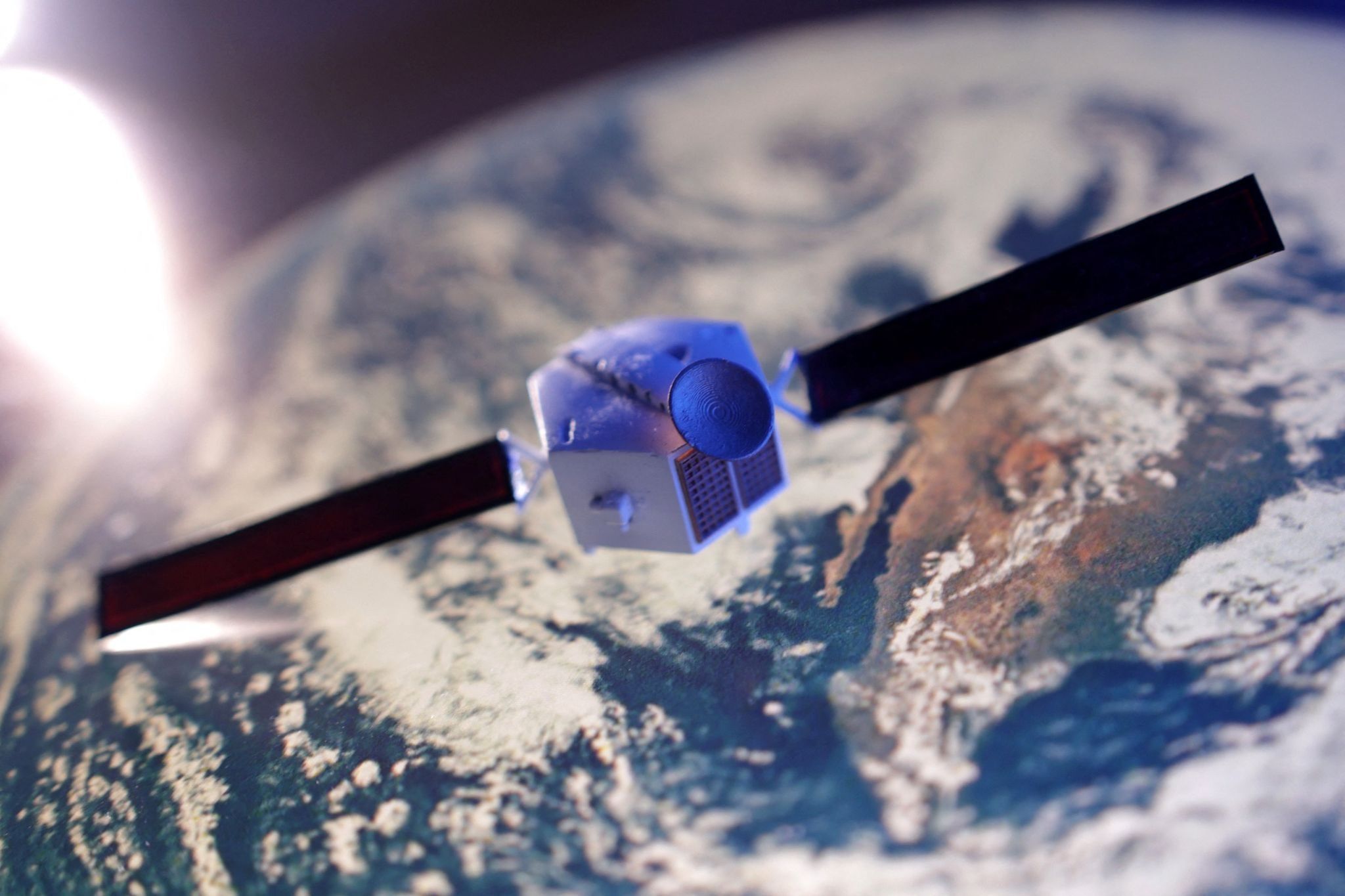 A satellite model is placed on a picture of Earth in this illustration taken November 25, 2024.
