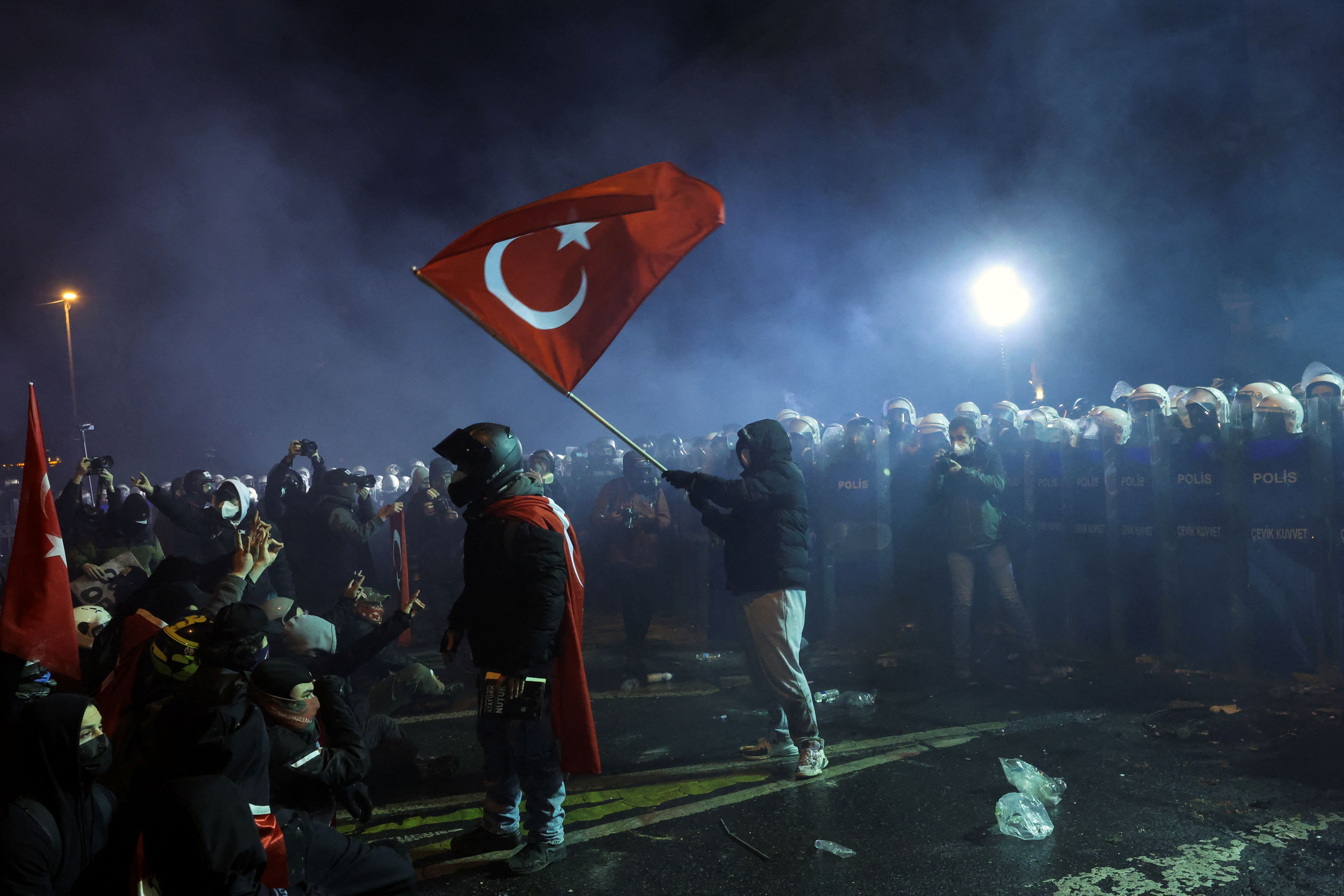 A demonstrator waves a Turkish flag, while taking part in a protest.