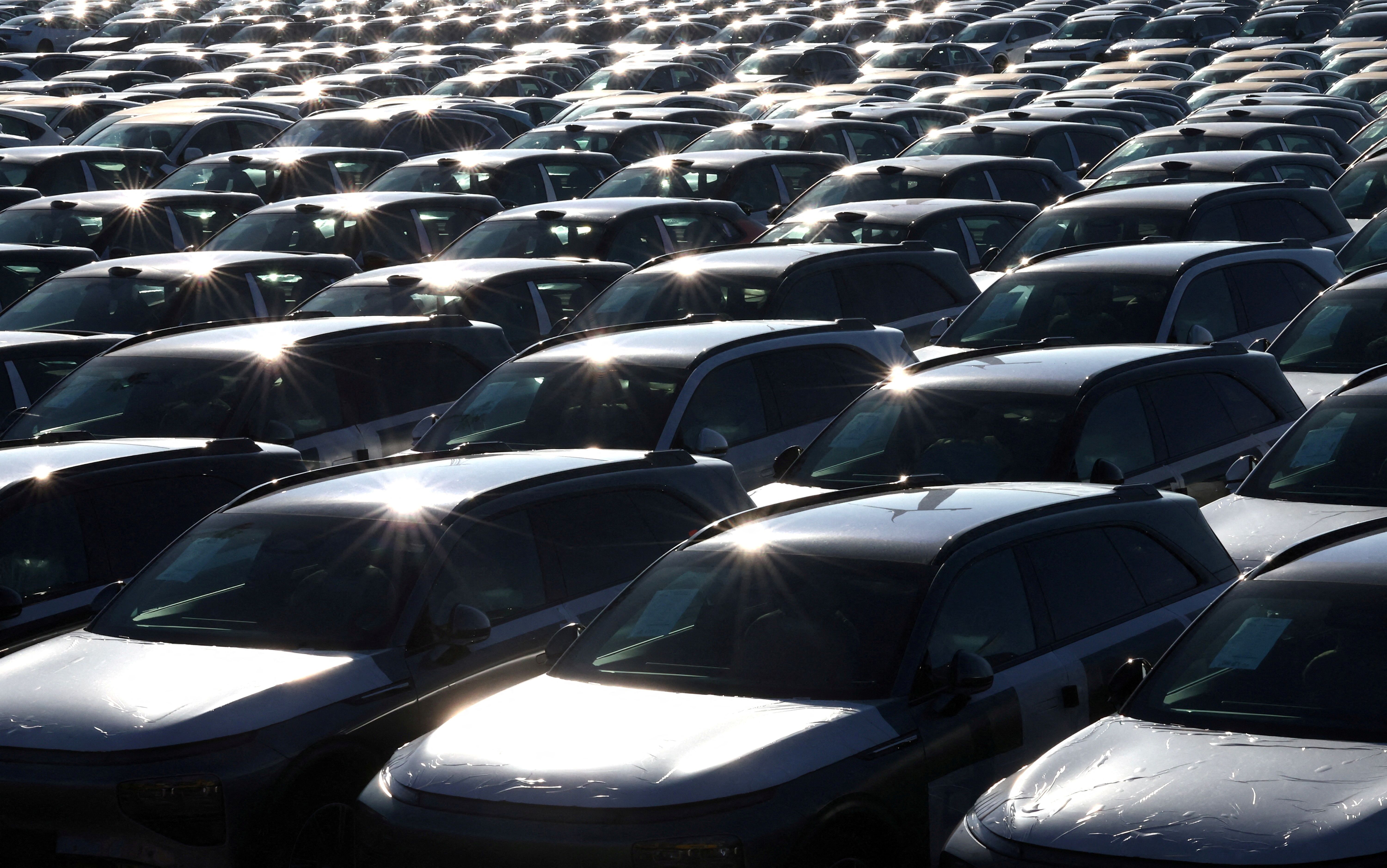 New cars, among them China-built electric vehicles of the company Xpeng, are seen parked in the port of Zeebrugge, Belgium.