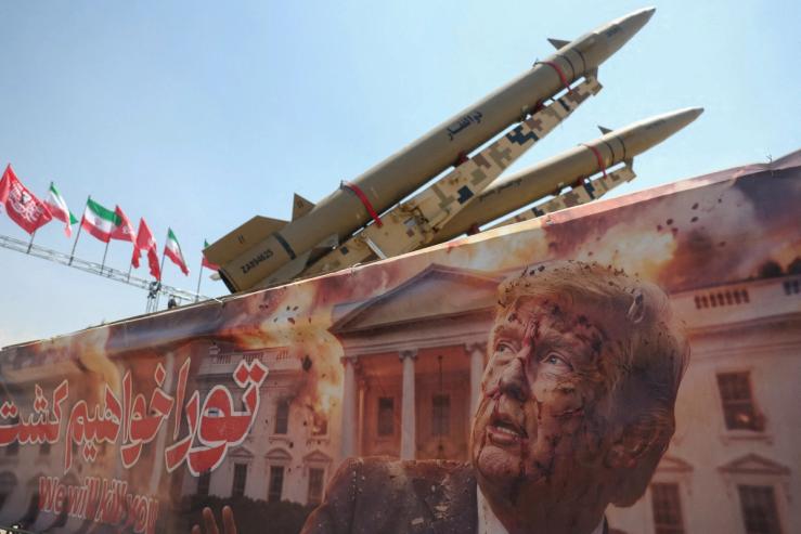 A banner with a picture of U.S. President Donald Trump next to an Iranian missile system at Azadi Square in Tehran, Iran.