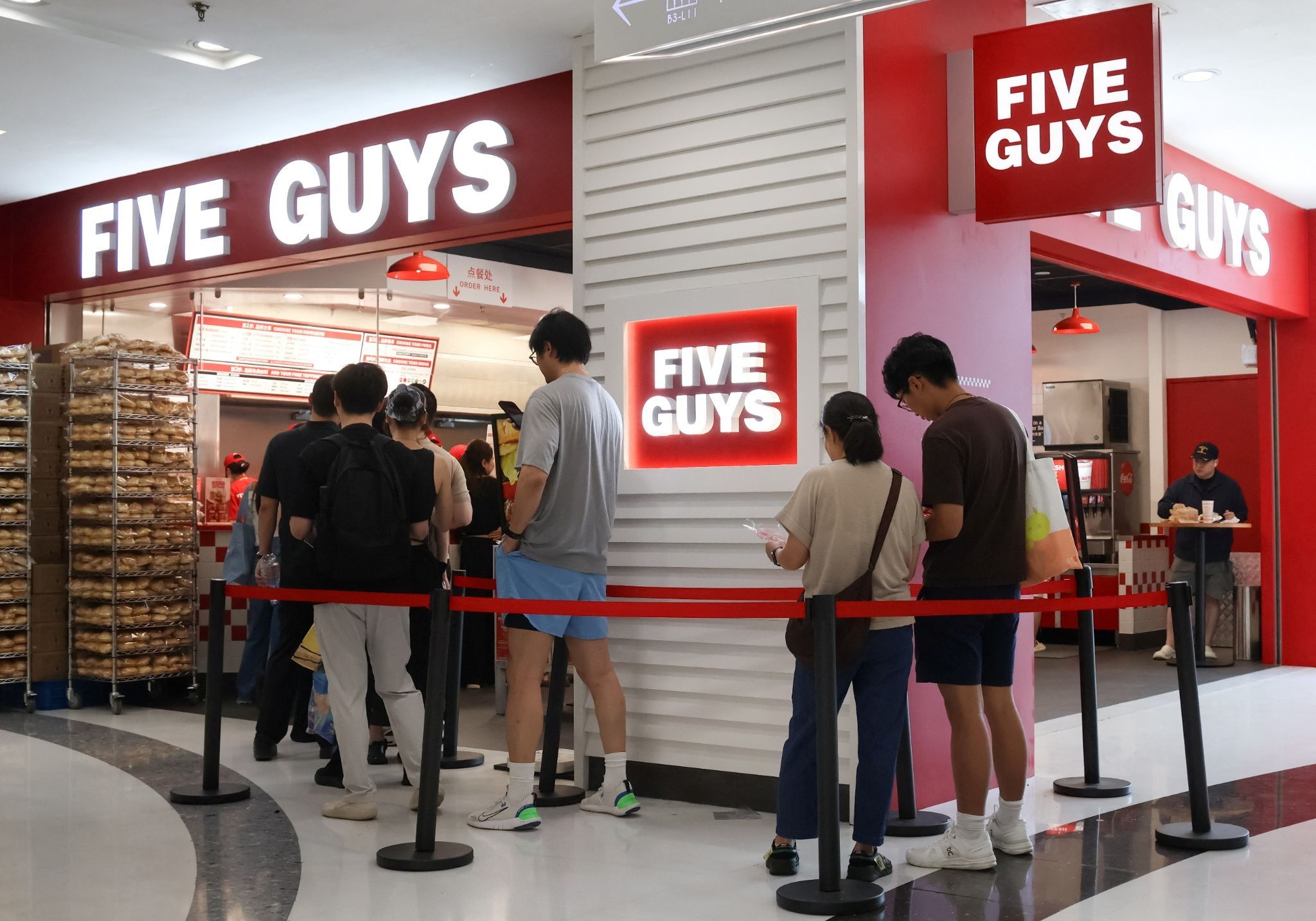 Chinese queue at a Five Guys restaurant