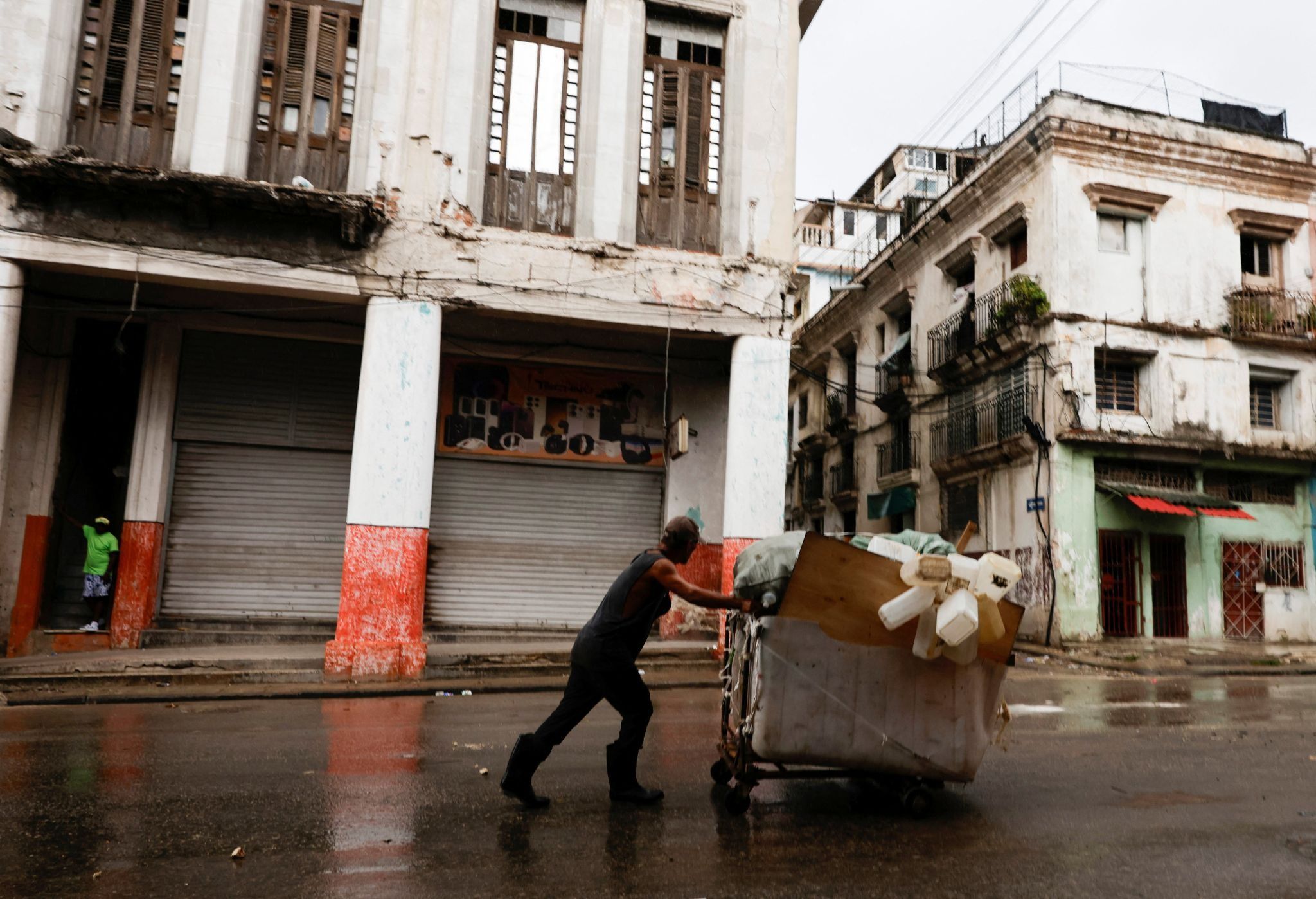 A man carrying salvaged plastic containers in Havana.