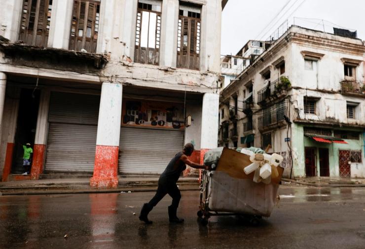 A man carrying salvaged plastic containers in Havana.