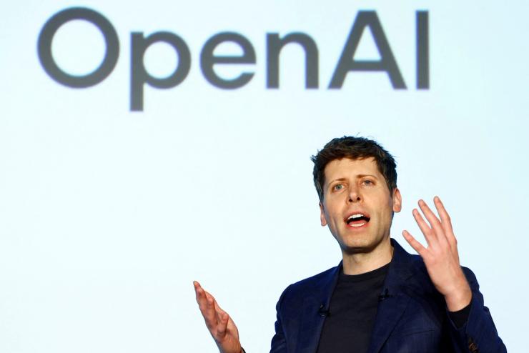 OpenAI CEO Sam Altman in front of an OpenAI logo