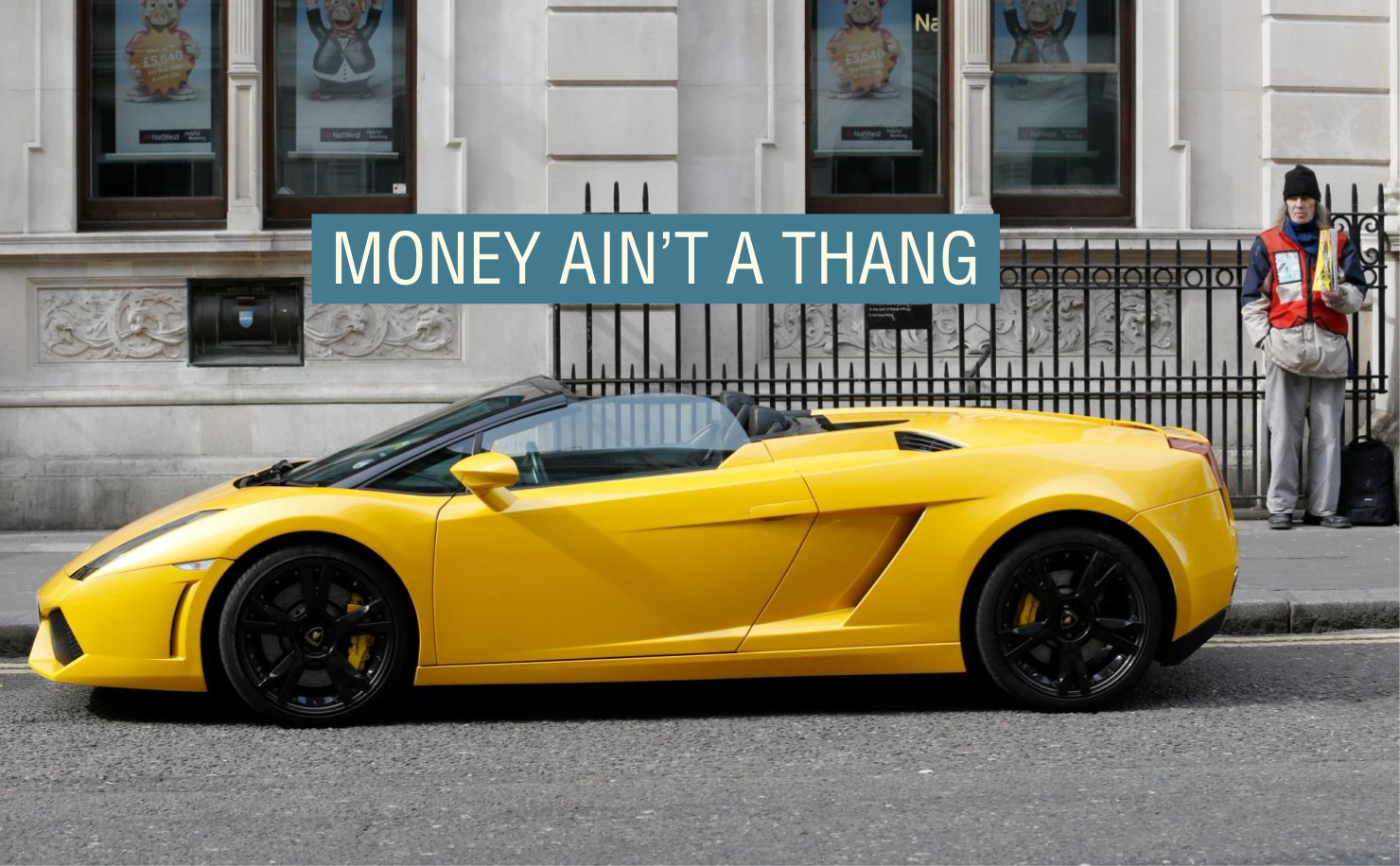 A man sells copies of the “Big Issue” next to a Lamborghini car in Covent Garden in central London.