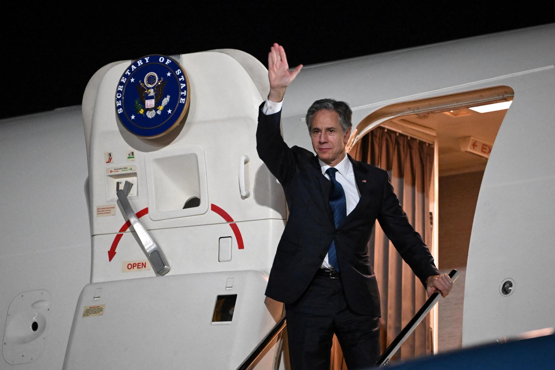 US Secretary of State Antony Blinken waves farewell as he boards his plane in Aqaba.