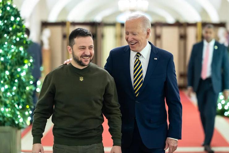 President Joe Biden pictured smiling while walking with Volodymyr Zelenskyy