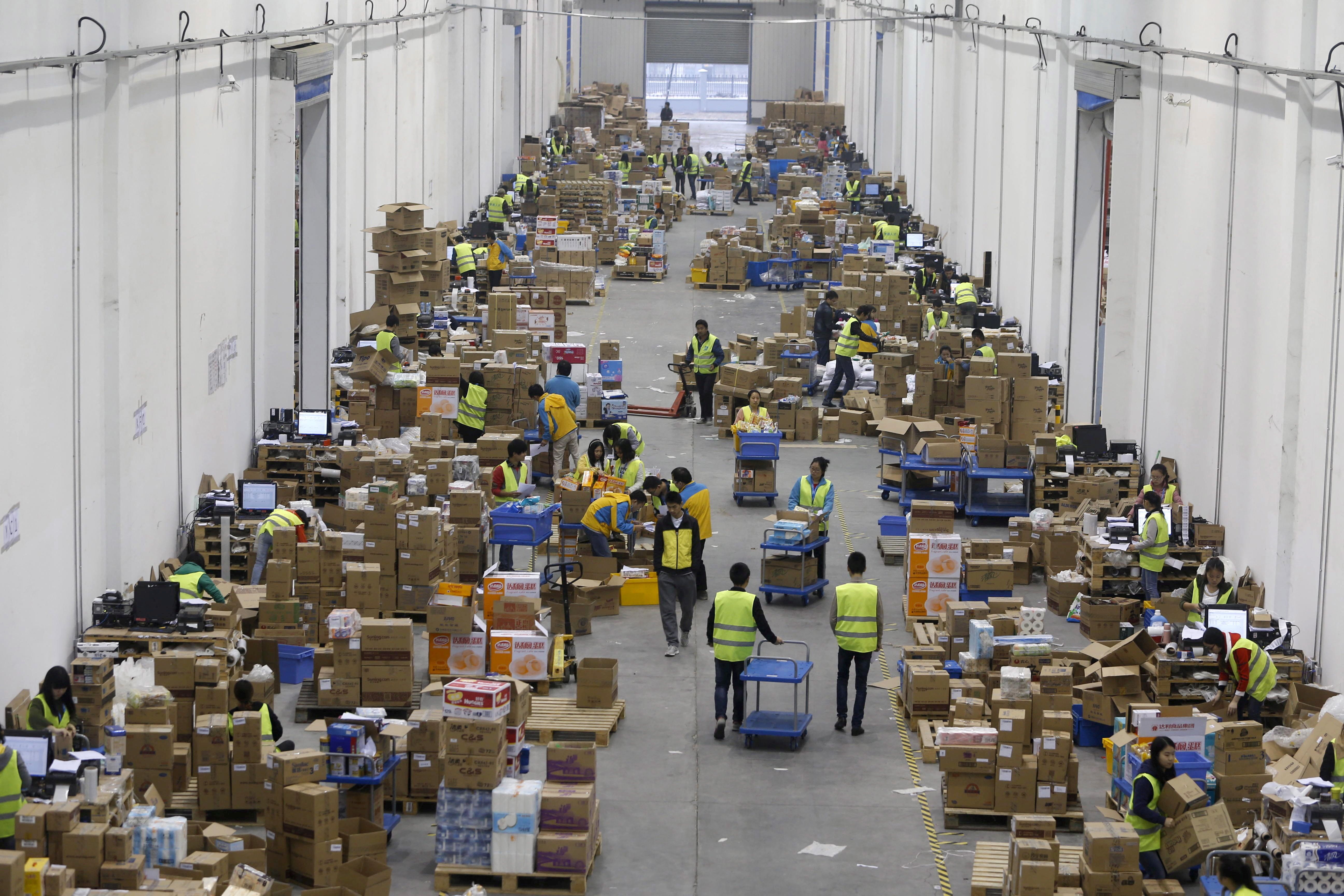 Employees sort boxes and parcels at the logistics centre of a express delivery company in Wuhan.