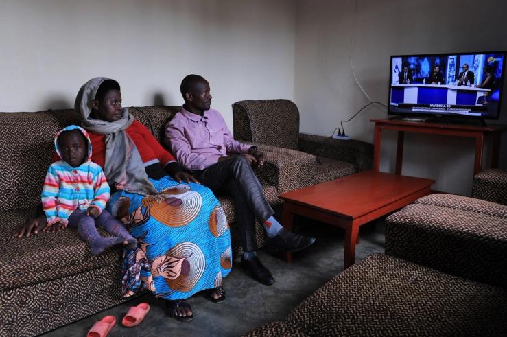 A family watching television in Rwanda in 2024.