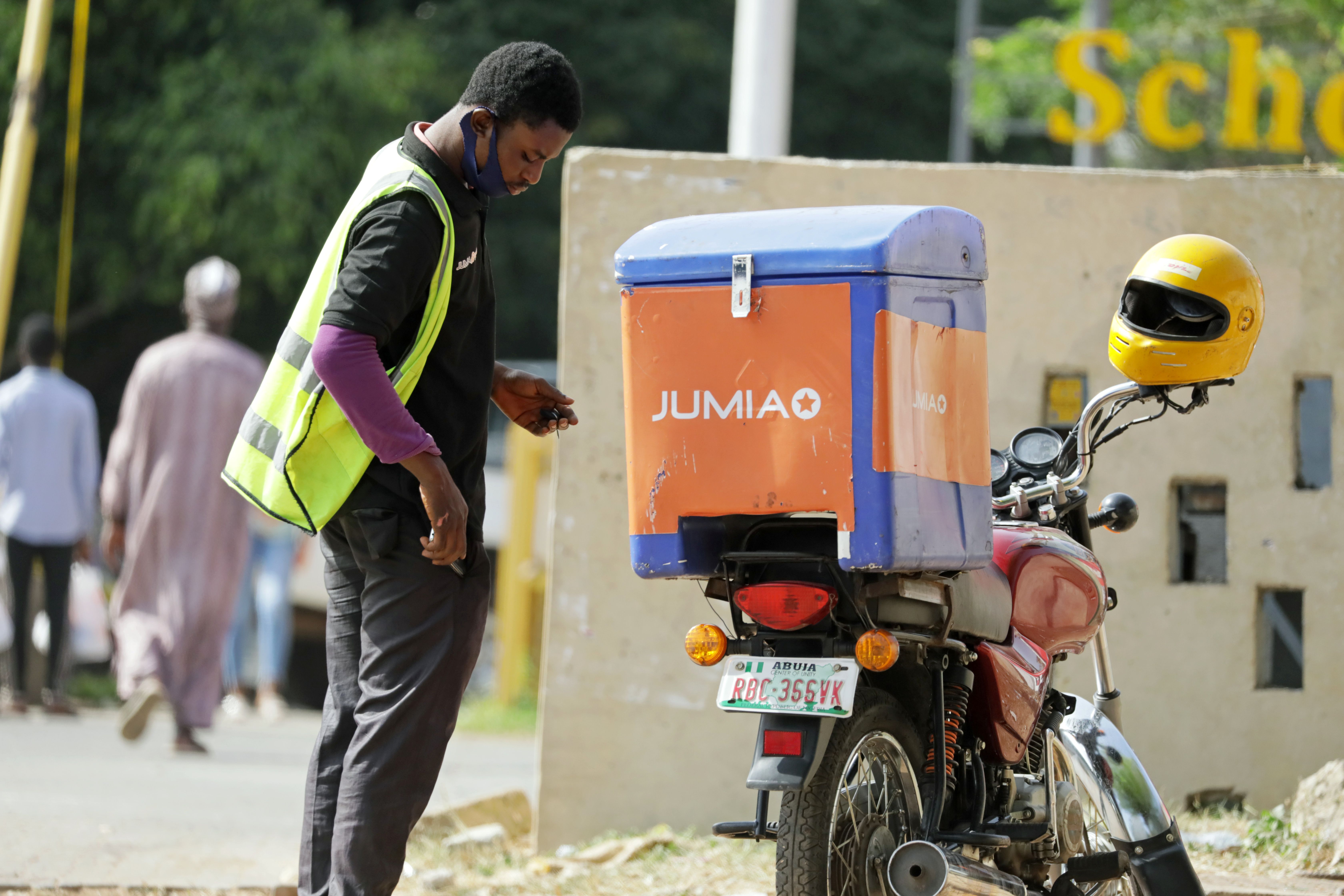 A dispatch rider for Jumia stands near his motorbike in Abuja, Nigeria November 9, 2020. Picture taken November 9, 2020. REUTERS/Afolabi Sotunde
