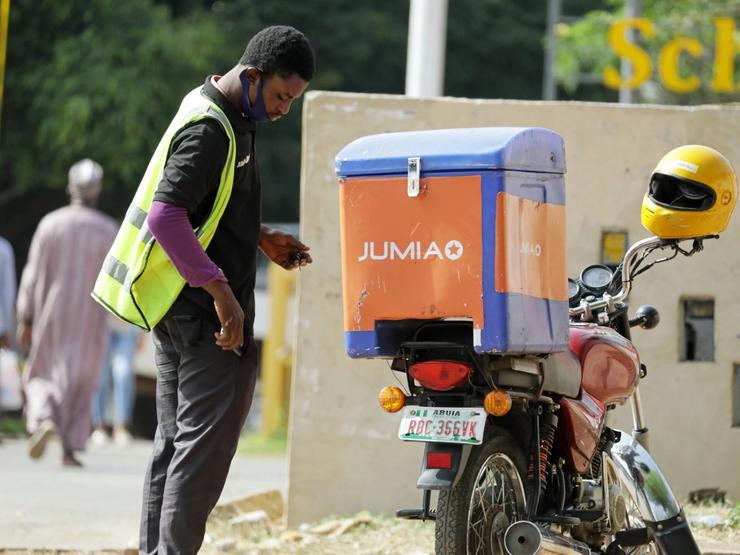 A dispatch rider for Jumia stands near his motorbike in Abuja, Nigeria November 9, 2020. Picture taken November 9, 2020. REUTERS/Afolabi Sotunde