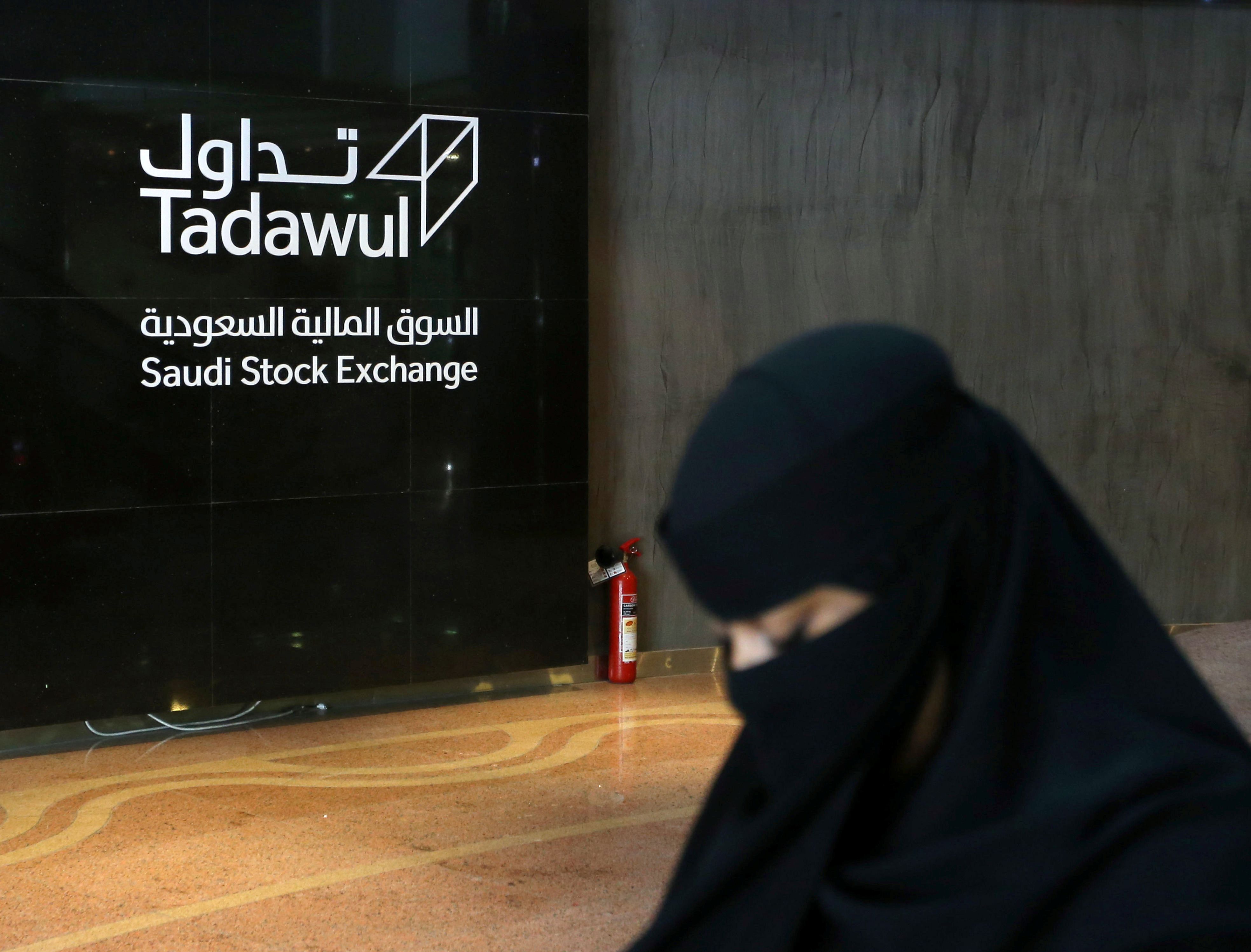 Saudi woman walks at the Saudi stock market Tadawul