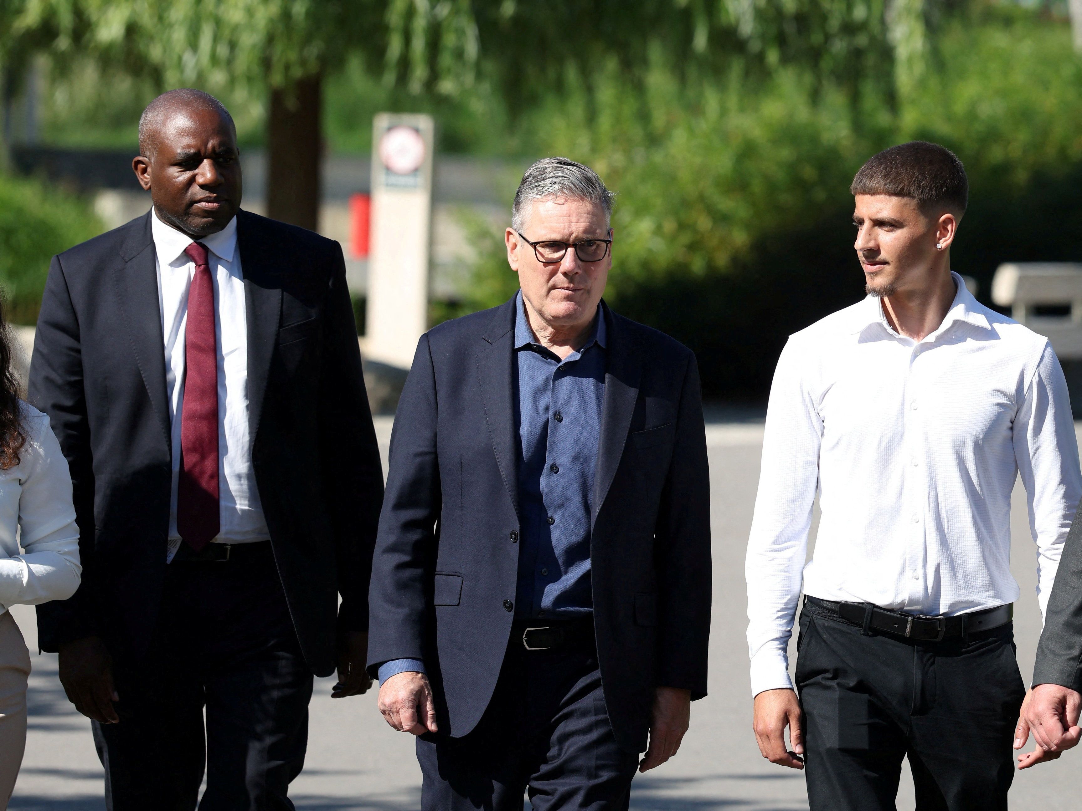 Britain’s Prime Minister Keir Starmer walks with British Deputy Prime Minister David Lammy as he visits a housing development in north London, Britain, June 19, 2026.