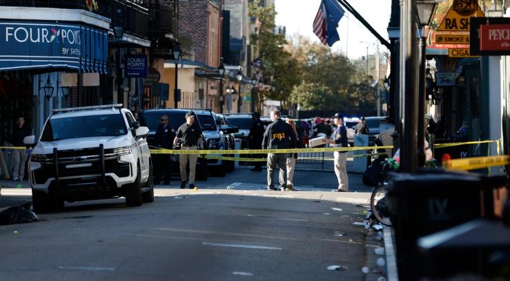 FBI officers stand on a restricted area of Bourbon Street in New Orleans.