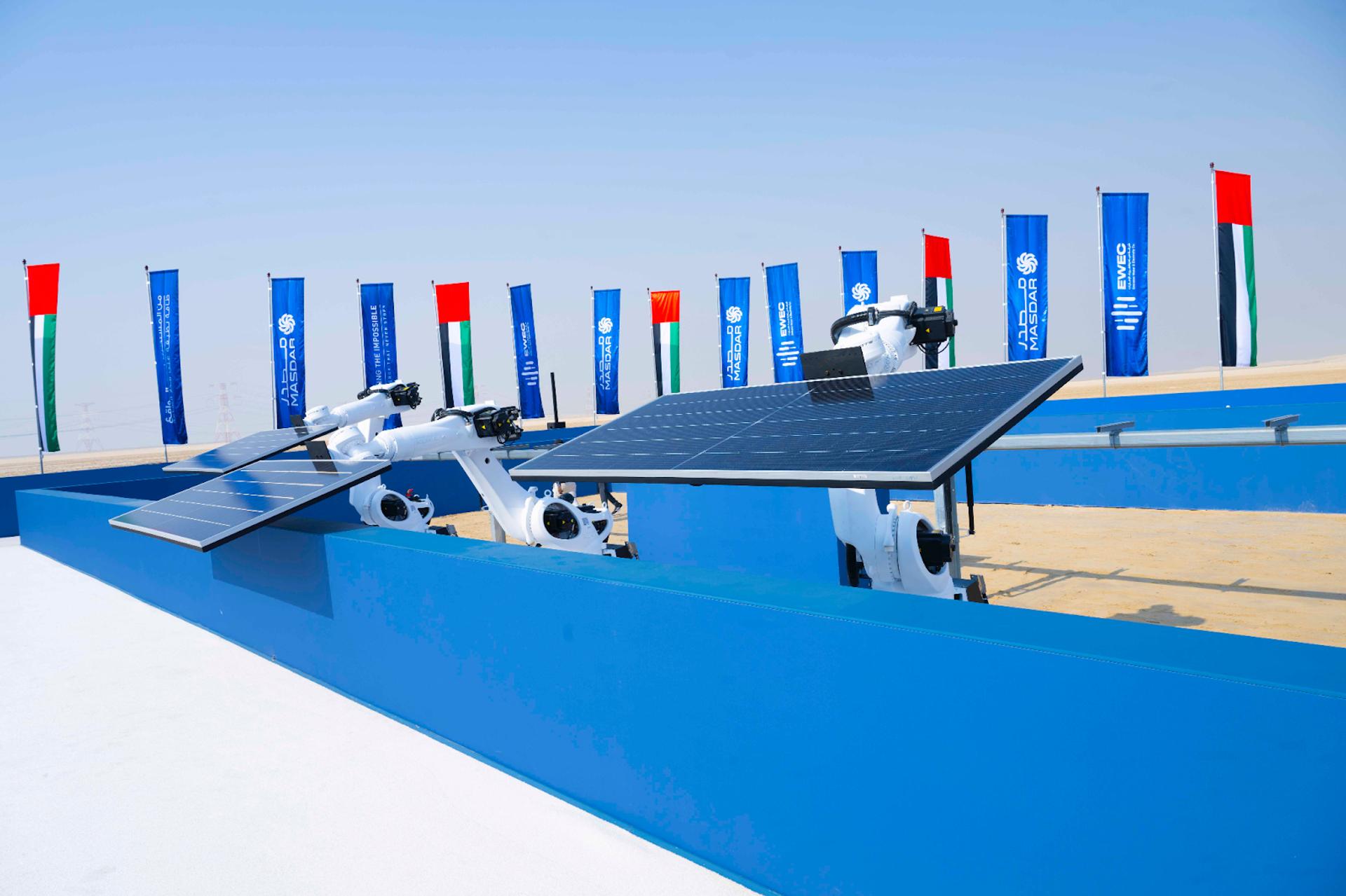 Robotic arms lift the first solar panels at Masdar’s 24/7 solar-and-battery park in Abu Dhabi, UAE on Oct. 23, 2025.