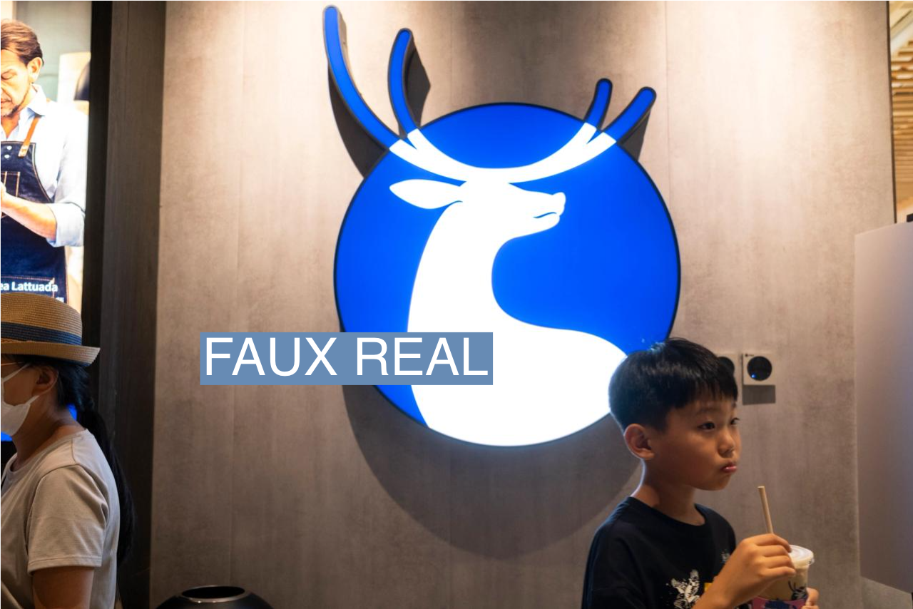 A boy walks past a Luckin Coffee store in Tianjin, China