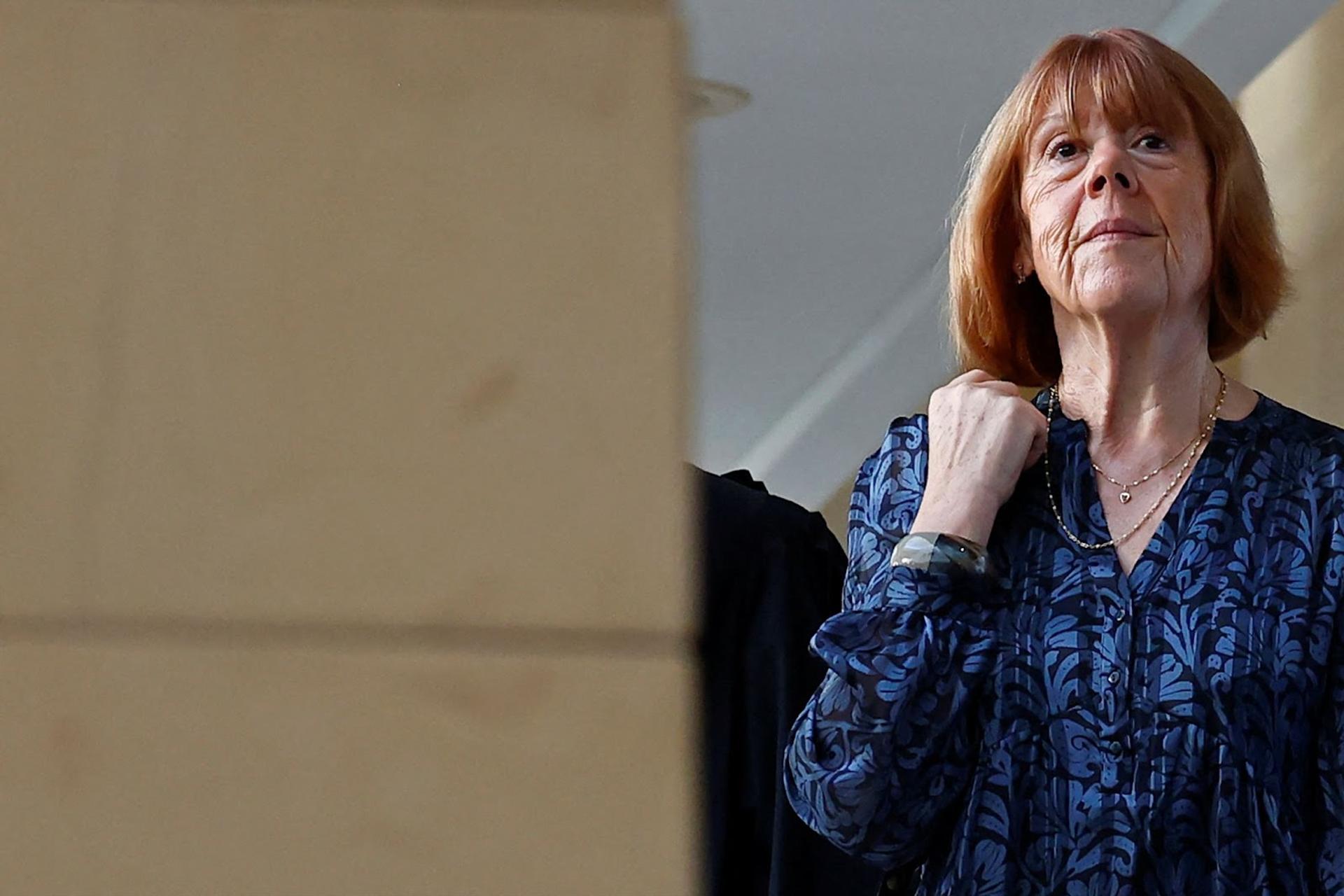 Gisèle Pelicot photographed in a blue blouse at a courthouse in Avignon, France