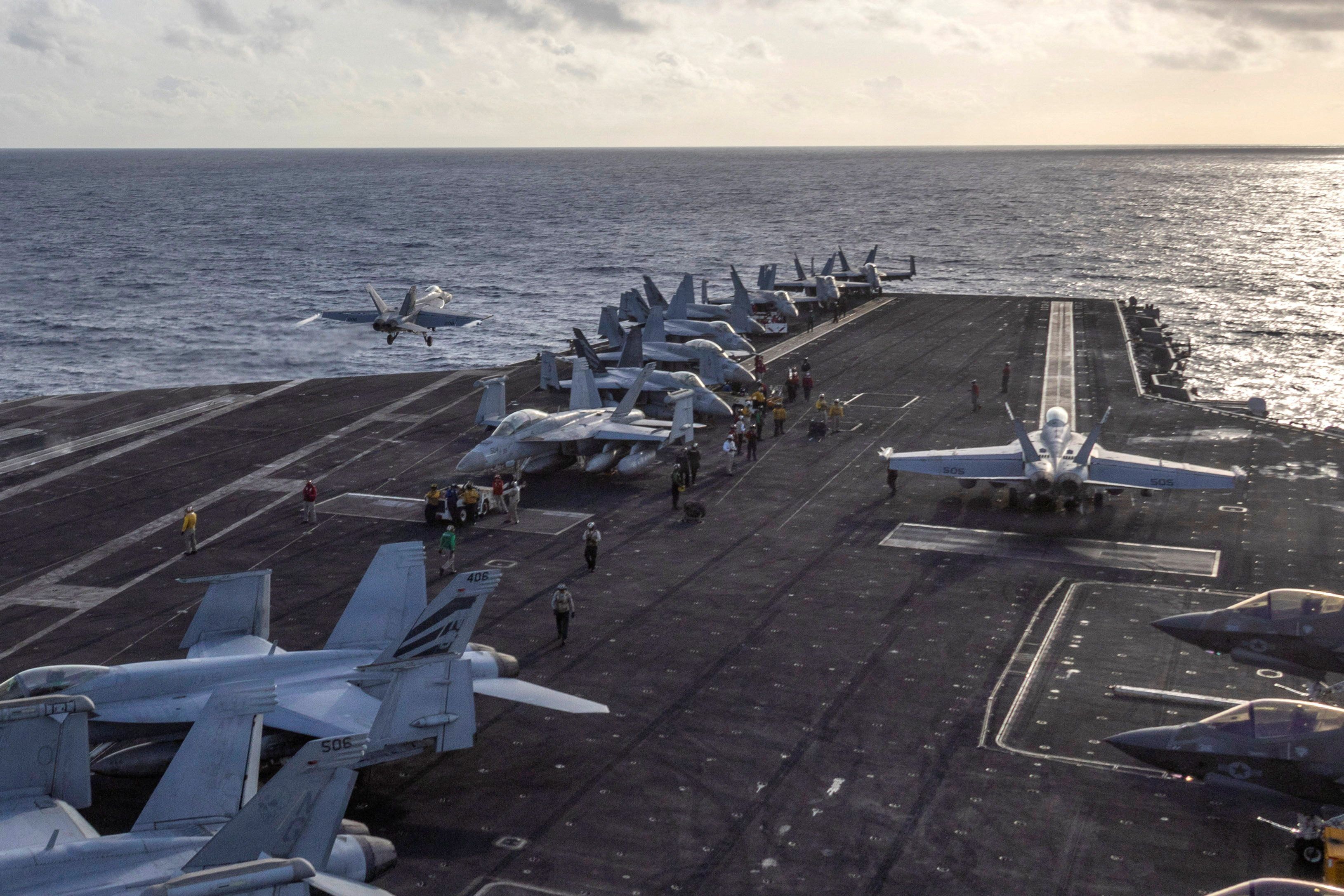 A Navy F/A-18E Super Hornet launches from the flight deck of the Nimitz-class aircraft carrier USS Abraham Lincoln