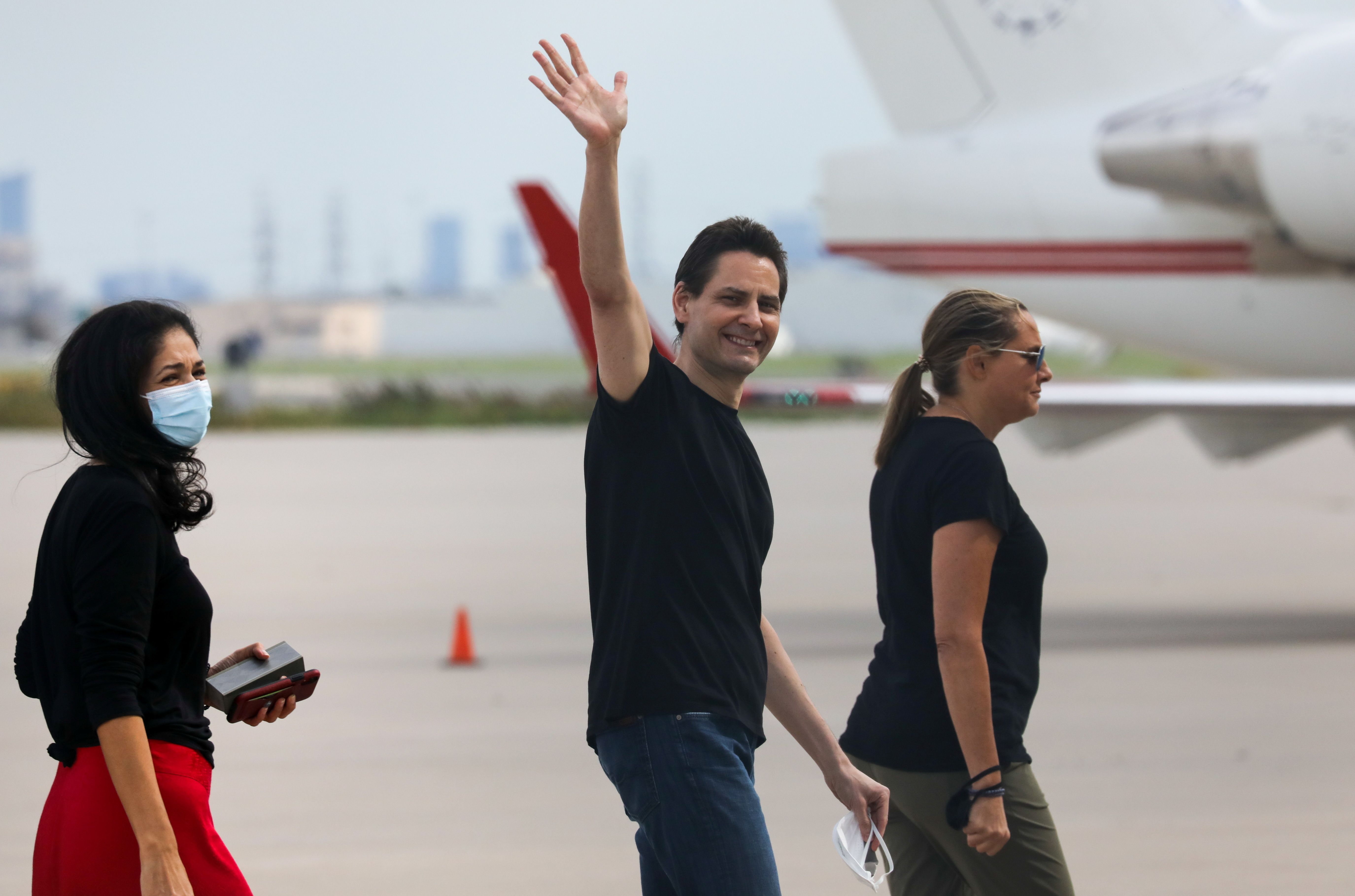 Former diplomat Michael Kovrig, his wife Vina Nadjibulla and sister Ariana Botha walk following his arrival on a Canadian air force jet after his release from detention in China.