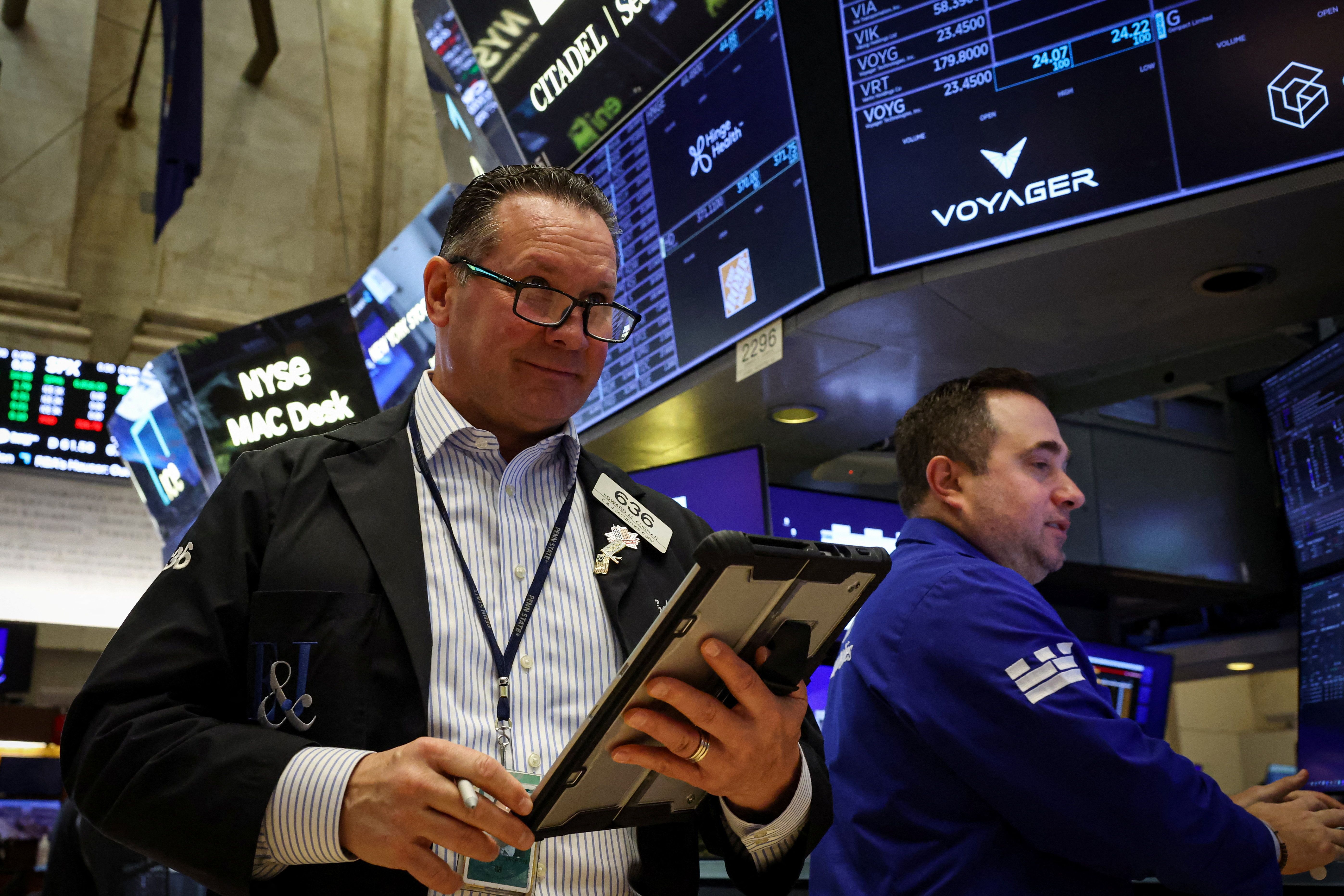 Traders work on the floor at the New York Stock Exchange (NYSE) in New York City