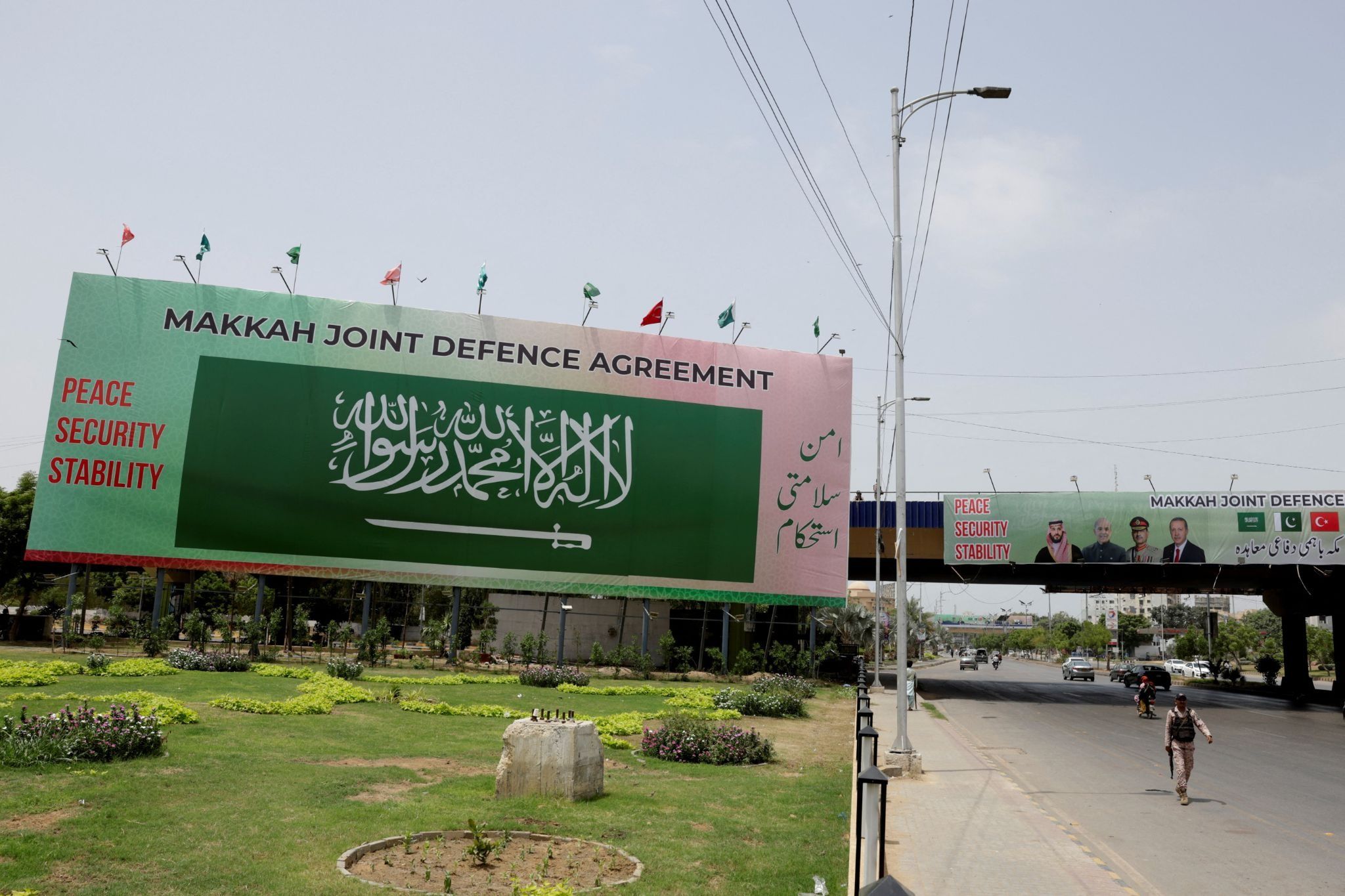 Billboard displays leaders following the signing of the Makkah Joint Defence Agreement, in Karachi.