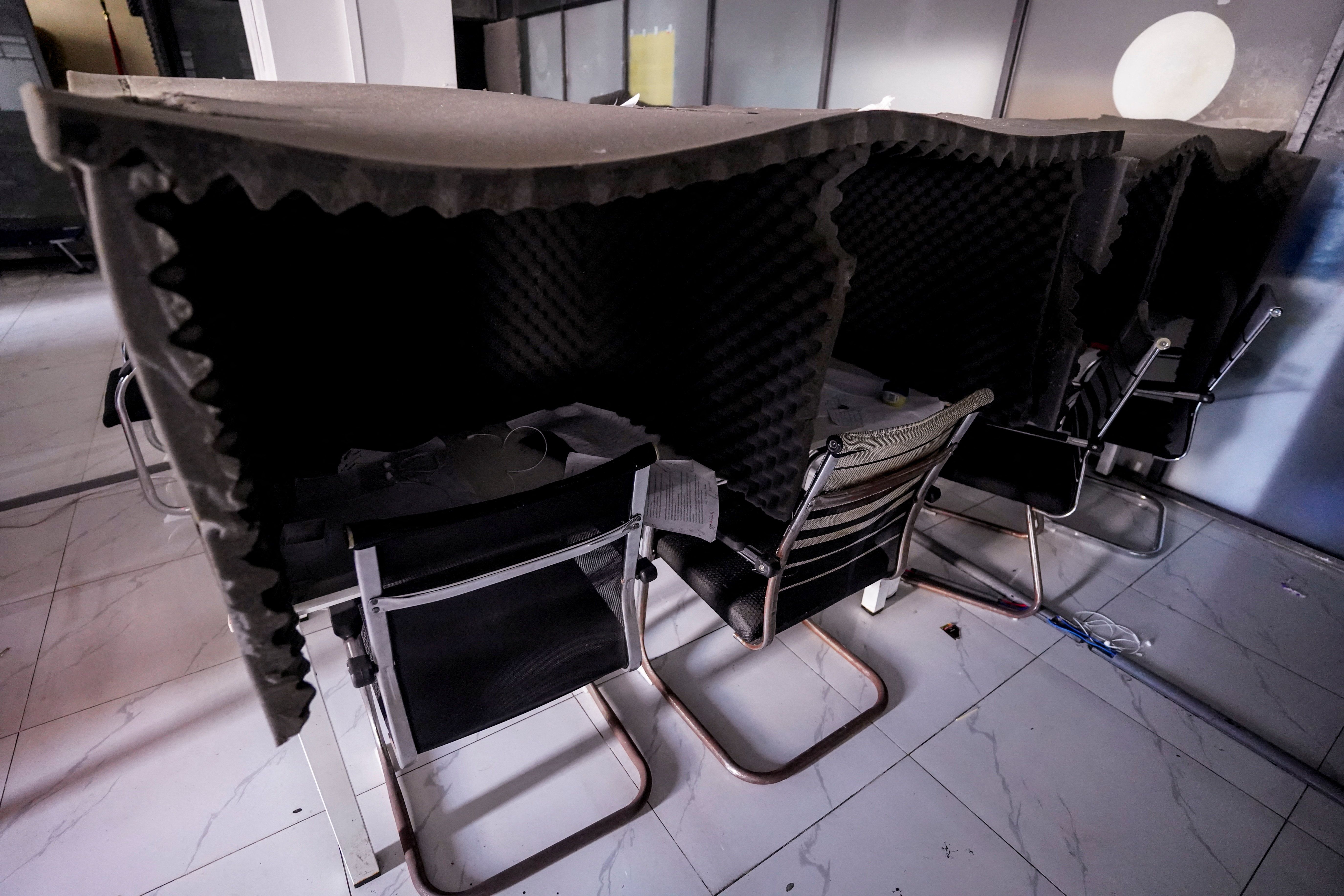 Desk lined with acoustic foam, which were used by scammers to make calls to victims, inside a scam compound known as “My Casino” used for fraud operations in Cambodia
