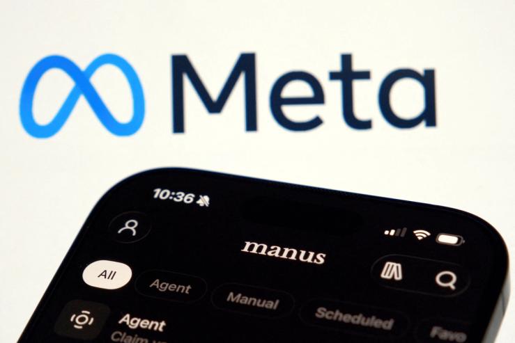 The Manus AI agent app is displayed on a mobile phone near the logo of US tech giant Meta.