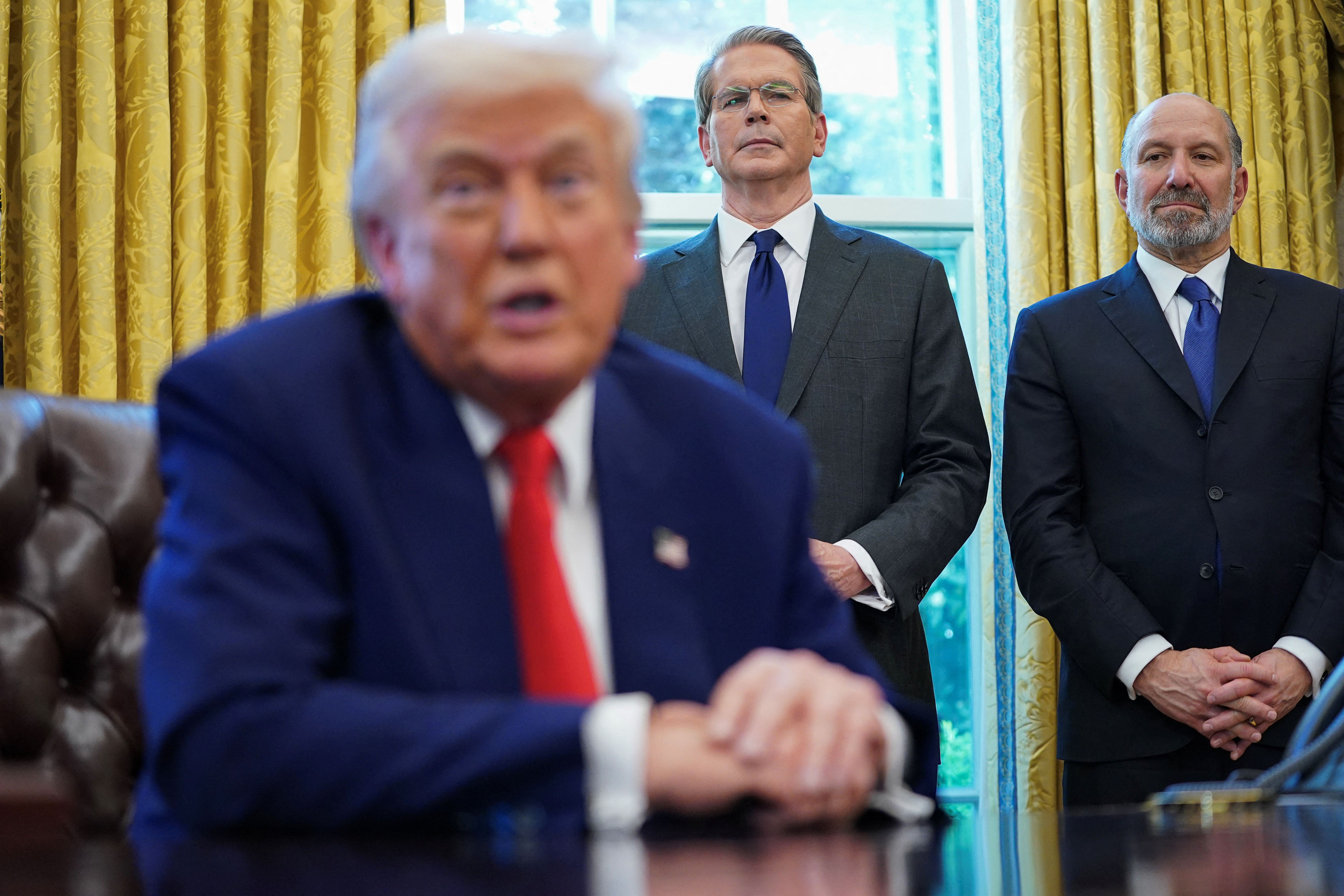 Commerce Secretary Howard Lutnick and Treasury Secretary Scott Bessent stand as President Donald Trump signs executive orders and proclamations in the Oval Office at the White House in Washington in April