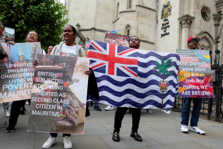Members of the British Chagossian community demonstrate ahead of the deal signing.