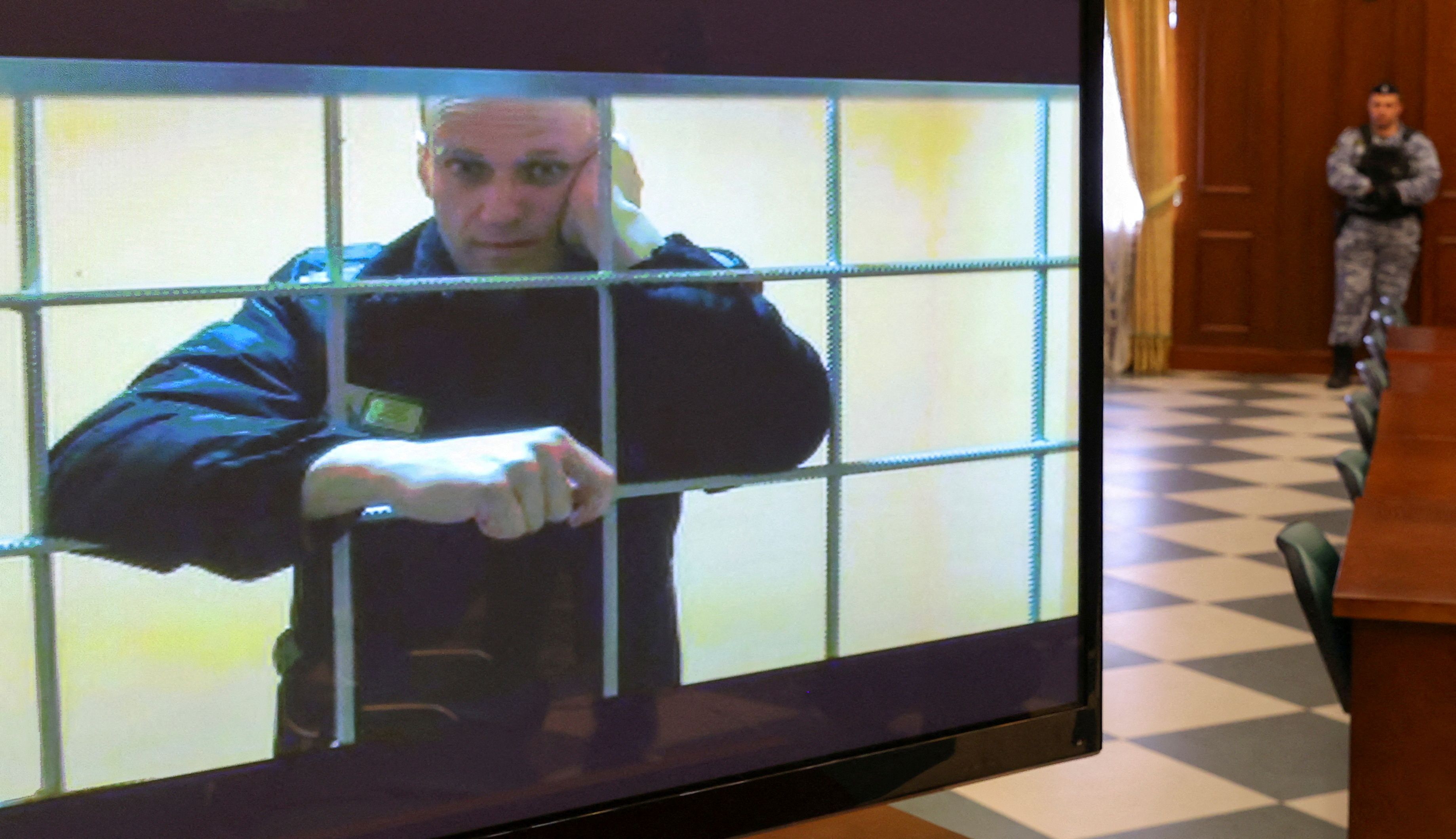 Russian opposition leader Alexei Navalny is seen on a screen via a video link from the IK-2 corrective penal colony in Pokrov during a court hearing to consider an appeal against his prison sentence in Moscow, Russia May 24, 2022. REUTERS/Evgenia Novozhenina/File Photo