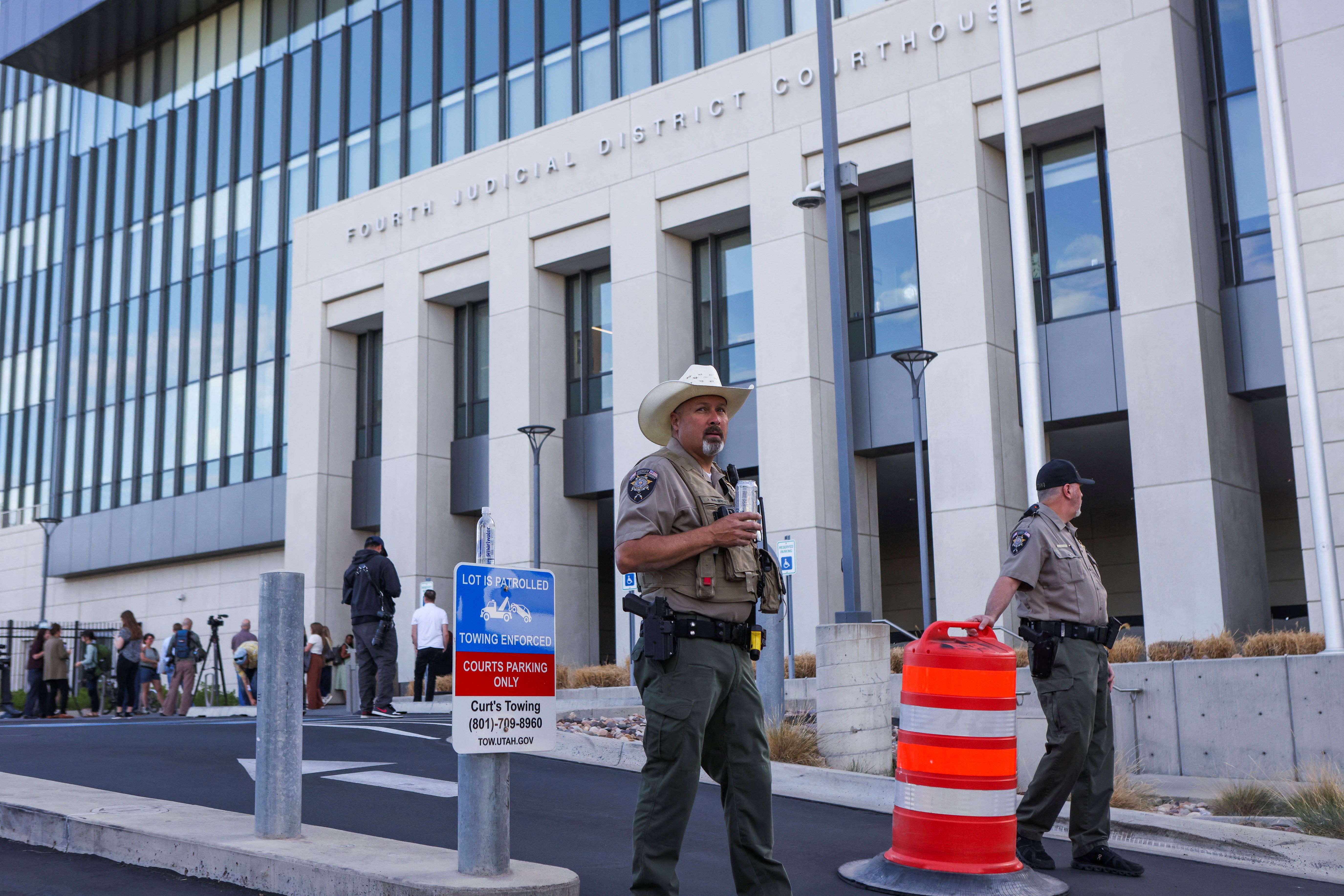 Law enforcement officers stand guard before a preliminary hearing for Tyler Robinson