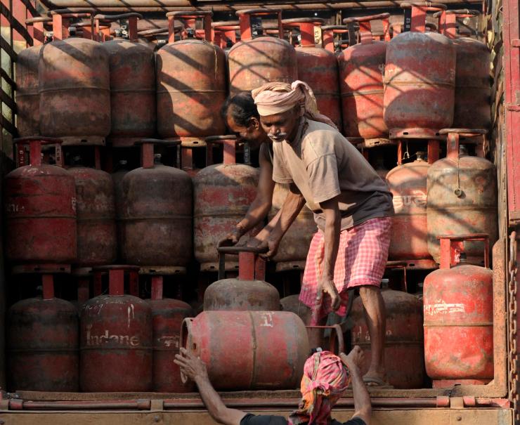 Employees from an Indian gas agency load cooking gas cylinders onto a truck in Agartala.