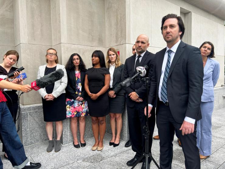 Cody Wofsy, a lawyer with the American Civil Liberties Union (ACLU), stands outside the federal court in New Hamsphire.