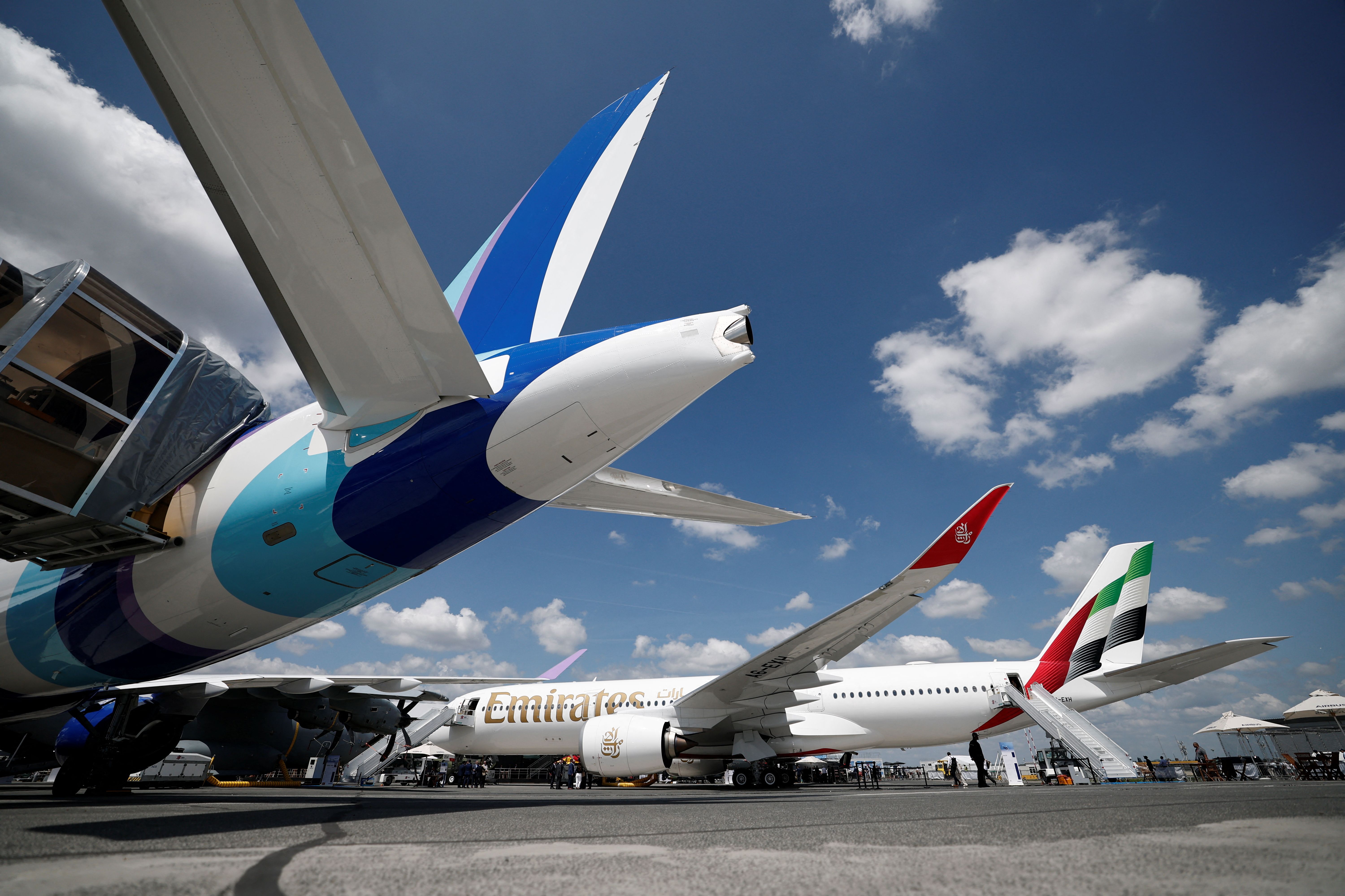 View of Airbus A220-300 JetBlue Airways and Airbus A350-941 with registration A6-EXH Emirates displayed at the 55th International Paris Airshow at Le Bourget Airport near Paris.