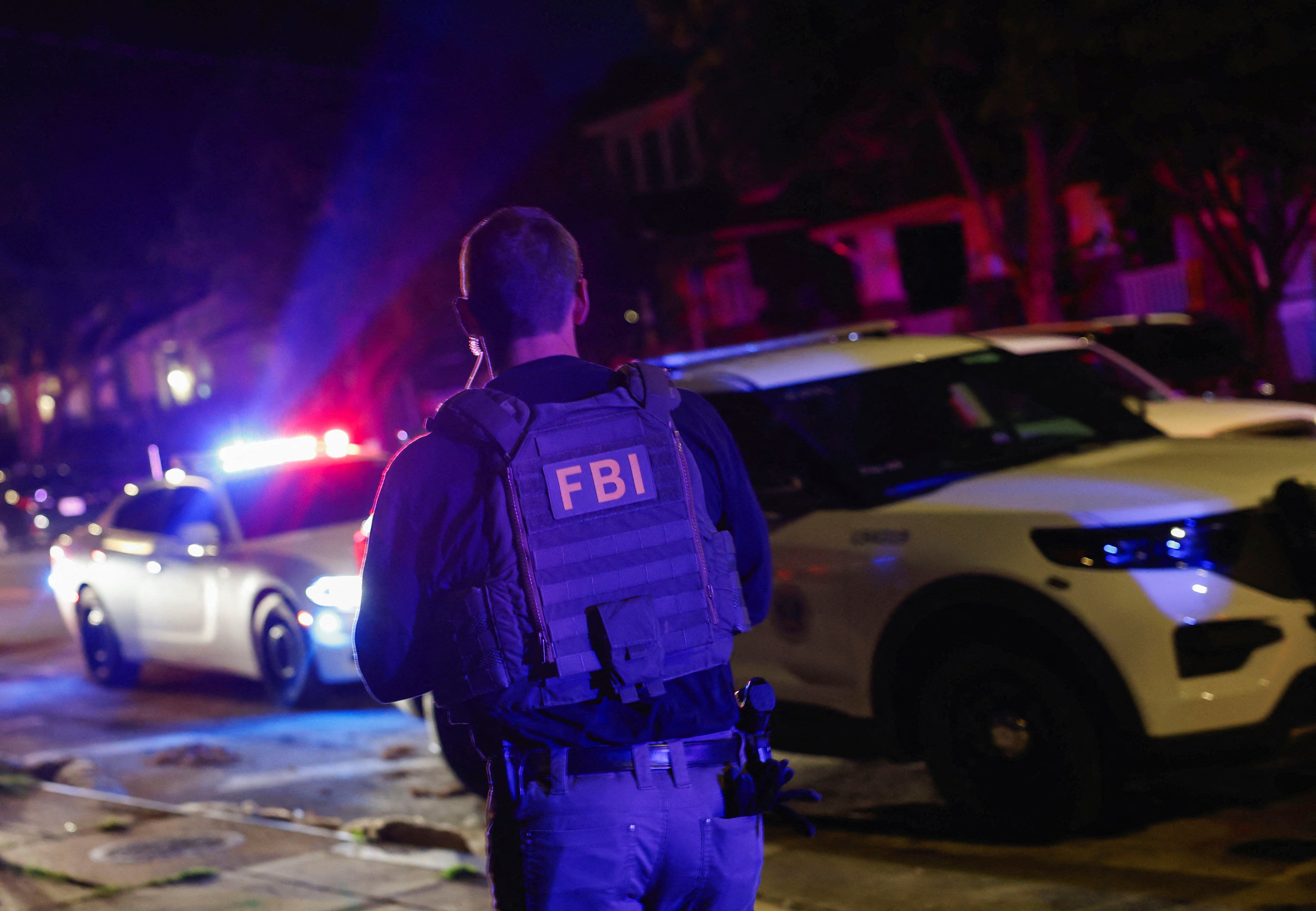 An FBI agent takes part in a police arrest in DC